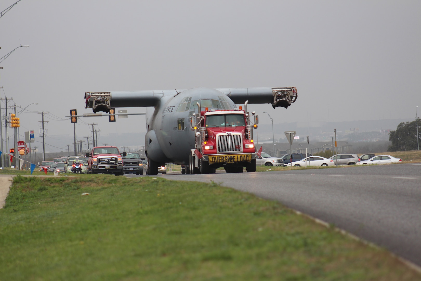 An Air Force C-130 Hercules cargo aircraft makes its way up Texas State Highway Loop 1604 to its final destination at Joint Base San Antonio-Camp Bullis Sunday.  It took about four hours to transport the aircraft across San Antonio.  The C-130 was diverted from decommissioning by the Puerto Rico Air National Guard and is now set to be a simulator trainer for about 1,300 students per year participating in the aeromedical evacuation and patient staging course at the Medical Readiness Training Center at JBSA-Camp Bullis. (U.S. Air Force photo by Marilyn C. Holliday)