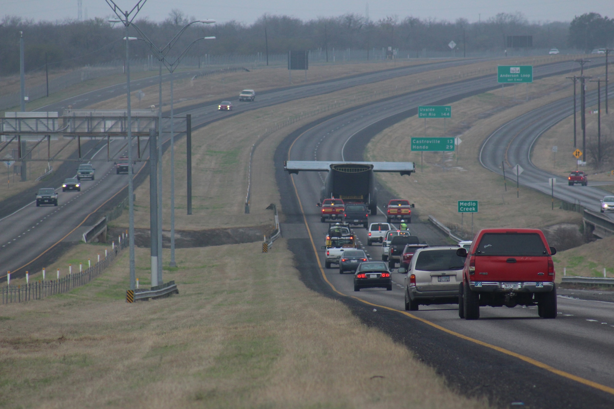 An Air Force C-130 Hercules cargo aircraft is towed across Hwy 90 East Sunday enroute from Joint Base San Antonio-Lackland to the 937th Training Group Medical Readiness Training Center at JBSA-Camp Bullis. (U.S. Air Force photo by Marilyn C. Holliday)