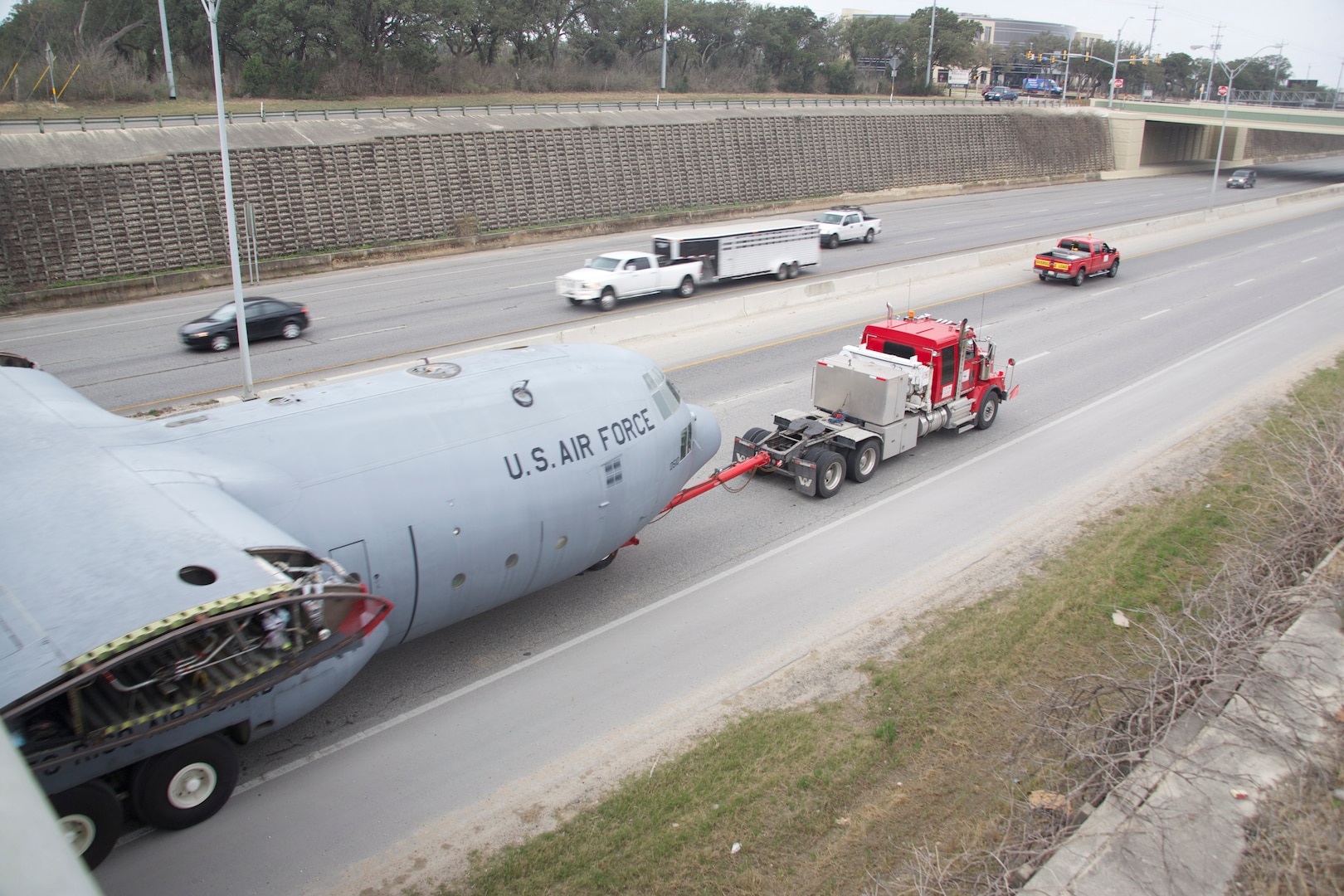 An Air Force C-130 Hercules cargo aircraft makes its way up Texas State Highway Loop 1604 to its final destination at Joint Base San Antonio-Camp Bullis Sunday.  It took about four hours to transport the aircraft across San Antonio.  The C-130 was diverted from decommissioning by the Puerto Rico Air National Guard and is now set to be a simulator trainer for about 1,300 students per year participating in the aeromedical evacuation and patient staging course at the Medical Readiness Training Center at JBSA-Camp Bullis. (U.S. Air Force photo by Dan Solis)