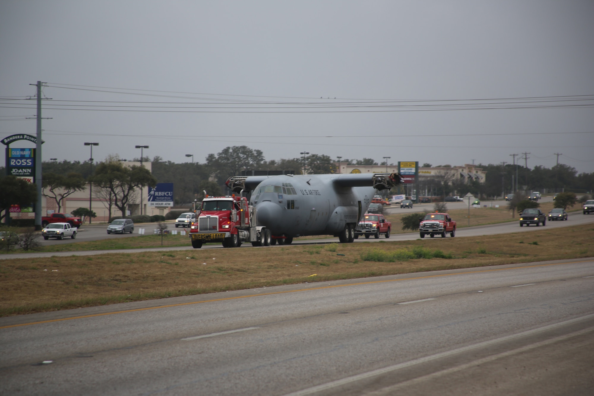An Air Force C-130 Hercules cargo aircraft makes its way up Texas State Highway Loop 1604 to its final destination at Joint Base San Antonio-Camp Bullis Sunday.  It took about four hours to transport the aircraft across San Antonio.  The C-130 was diverted from decommissioning by the Puerto Rico Air National Guard and is now set to be a simulator trainer for about 1,300 students per year participating in the aeromedical evacuation and patient staging course at the Medical Readiness Training Center at JBSA-Camp Bullis. (U.S. Air Force photo by Dan Solis)