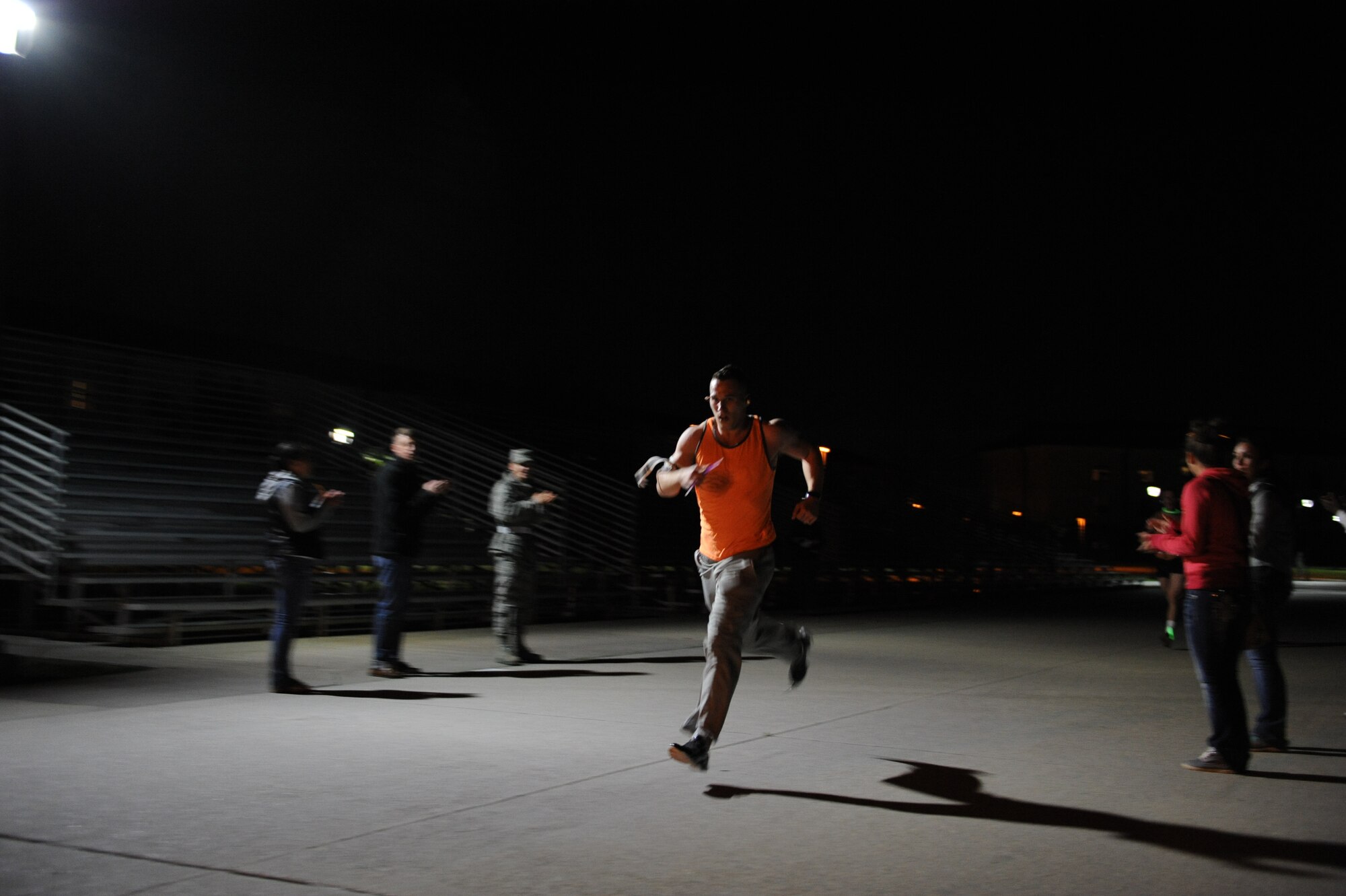Airman 1st Class Ryan Hallemeier, 338th Training Squadron student, wins 1st place in a 5k glow run hosted by the 81st Training Group teal rope program Feb. 27, 2014, at the Levitow Training Facility, Keesler air Force Base, Miss. The event was held to promote awareness of sexual assault and raise money for a local charity. (U.S. Air Force photo by Airman 1st Class Stephan Coleman)