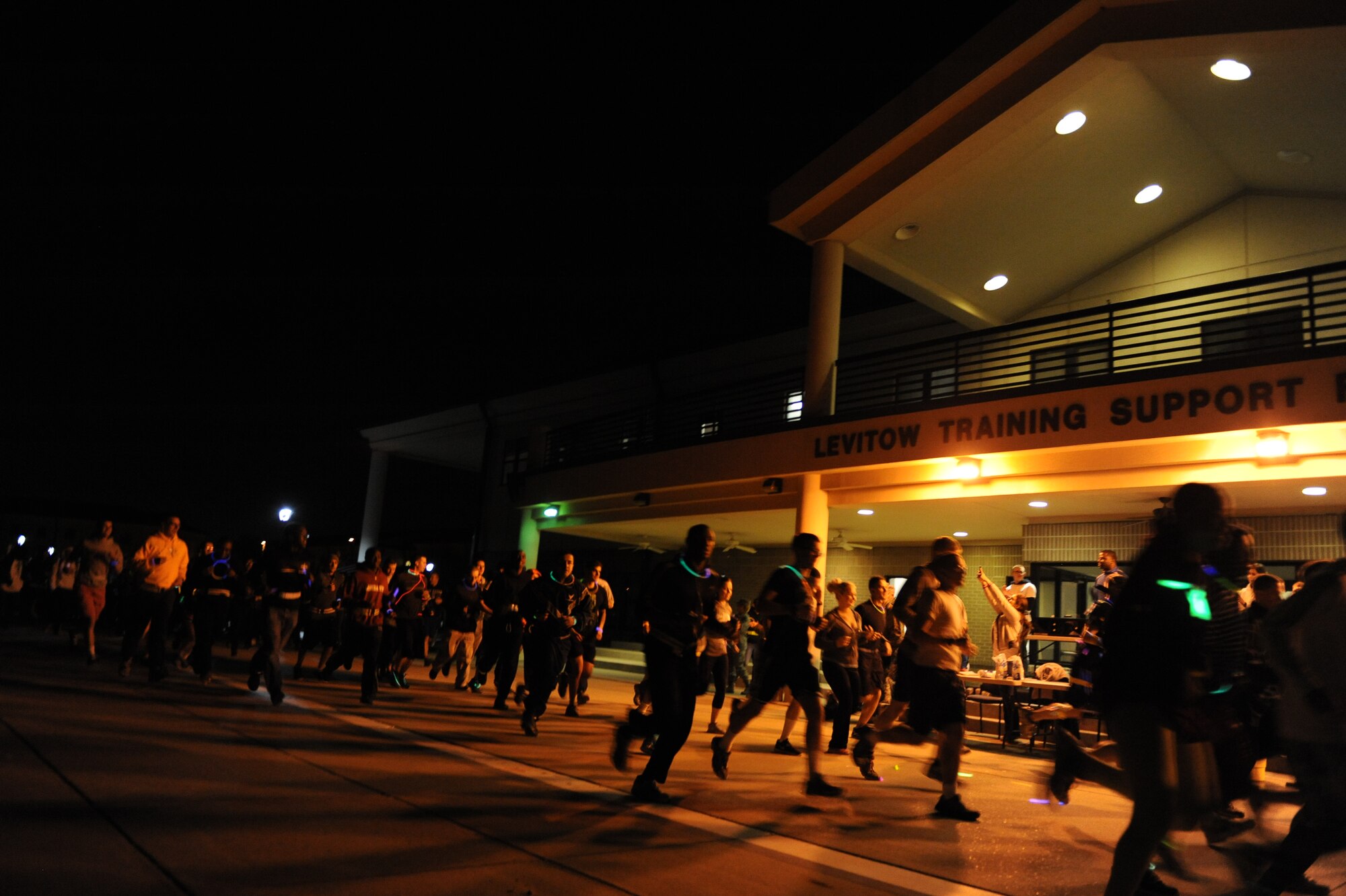 Technical training Airmen begin a 5k glow run hosted by the 81st Training Group teal rope program Feb. 27, 2014, at the Levitow Training Facility, Keesler air Force Base, Miss. The event was held to promote awareness of sexual assault and raise money for a local charity. (U.S. Air Force photo by Airman 1st Class Stephan Coleman)