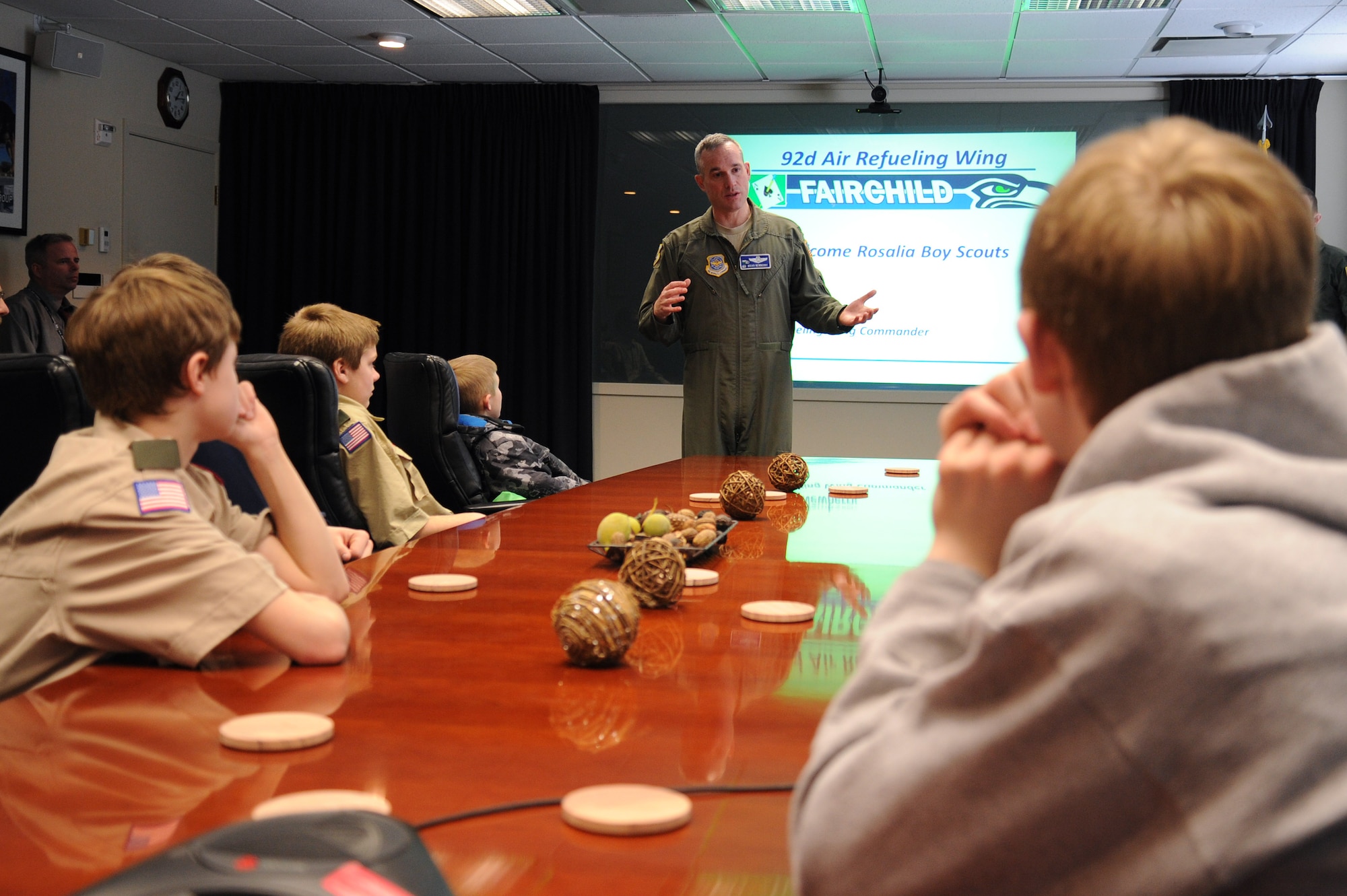 Col. Brian Newberry, 92nd Air Refueling Wing commander, speaks with Rosalia Boy Scouts during a base tour at Fairchild Air Force Base, Wash., Feb. 26, 2014. Members received a tour that held stops at the Aerospace Physiology, Hangar One for a KC-135 Stratotanker static display, Flight Simulator and Headquarters Building. (U.S. Air Force photo by Airman 1st Class Janelle Patiño/Released)
