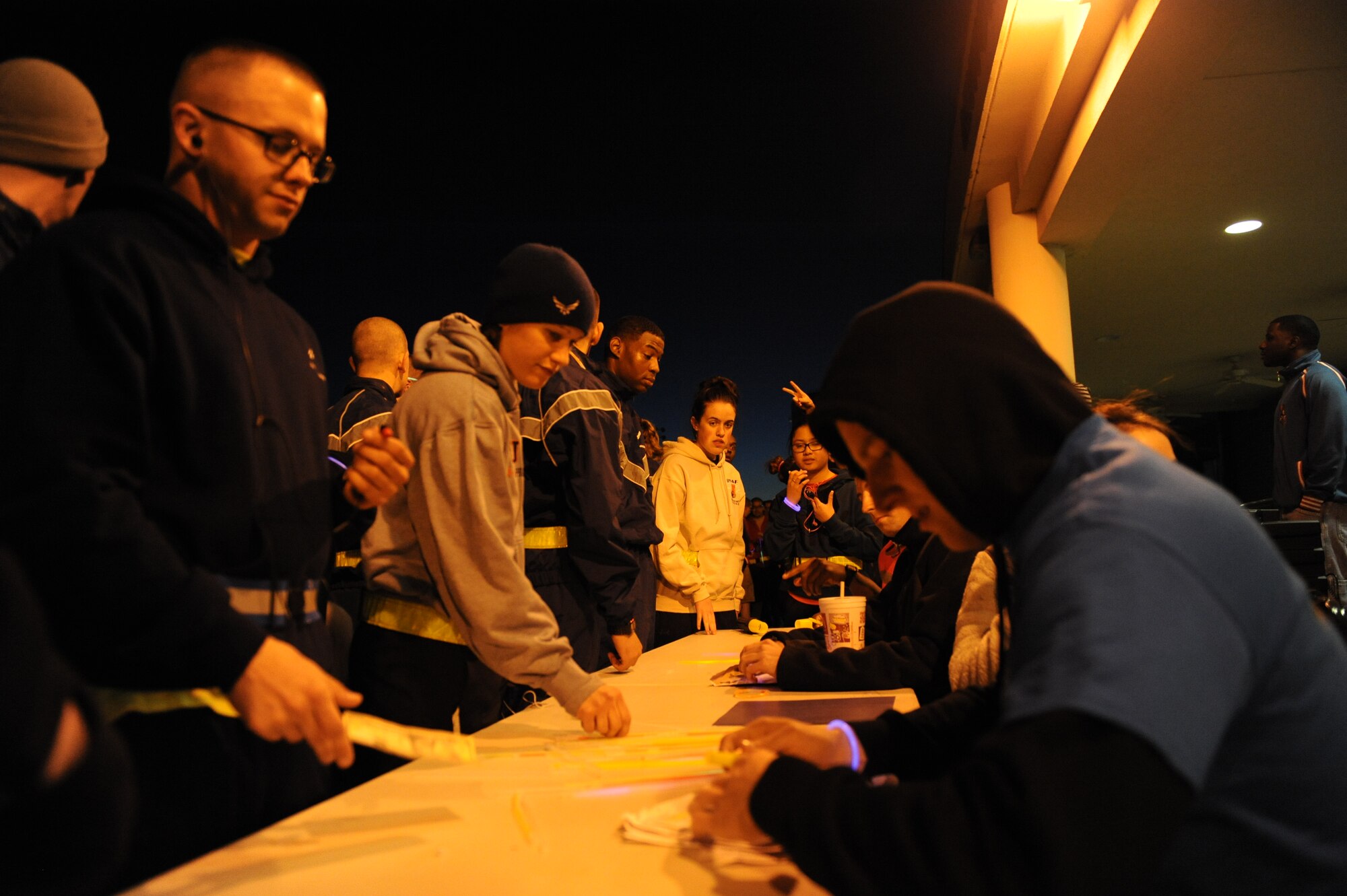 Technical training Airmen sign up for a 5k glow run hosted by the 81st Training Group teal rope program Feb. 27, 2014, at the Levitow Training Facility, Keesler air Force Base, Miss. The event was held to promote awareness of sexual assault and raise money for a local charity. (U.S. Air Force photo by Airman 1st Class Stephan Coleman)
