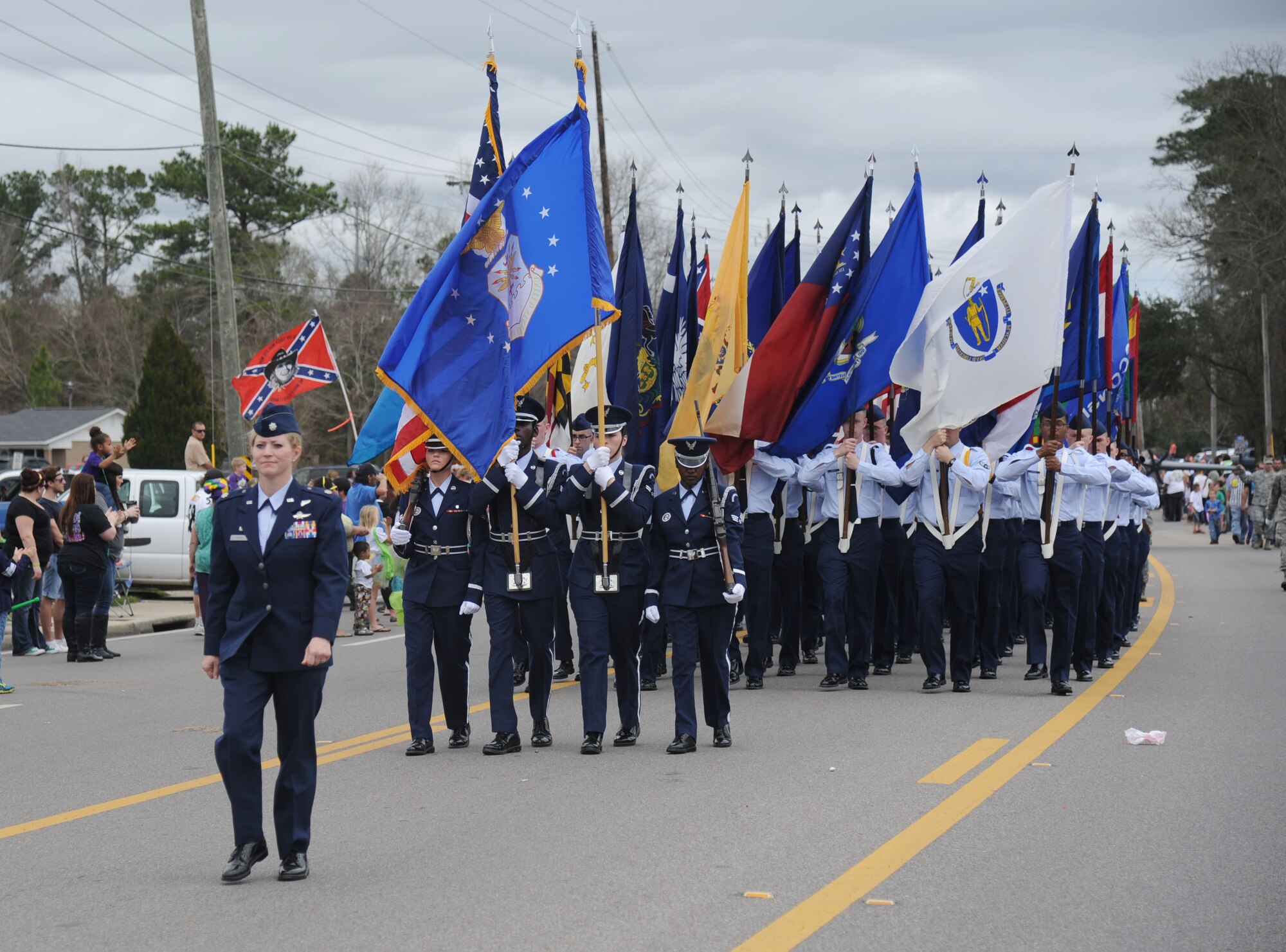Lt. Col. Michelle Carns, 338th Training Squadron commander, leads the Keesler Honor Guard and Airmen carrying the 50 state flags during the 26th Annual North Bay Area Mardi Gras Parade in D’Iberville, Miss., March 2, 2014.  Leadership from the 81st Training Wing and the 81st Training Group drum and bugle corps also participated in the festivities.  (U.S. Air Force photo by Kemberly Groue)