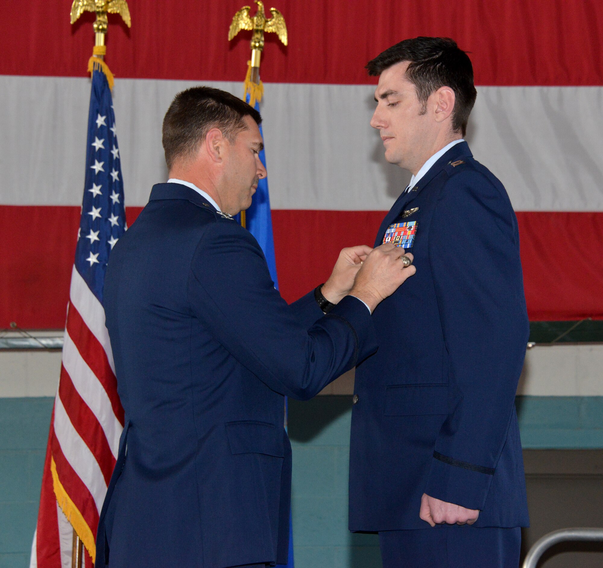 Col. Vincent Becklund (left), 58th Special Operations Wing commander, pins the Distinguished Flying Cross on Capt. R.J. Donaldson, 58th Training Squadron, during a ceremony March 3 at Kirtland Air Force Base. The captain was recognized for his May 26, 2011, mission as an HH-60G helicopter aircraft commander in Afghanistan to conduct a combat rescue of wounded U.S. Army Soldiers. (Photo by Dennis Carlson)  