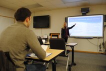Bonnie Bauman explains what children up to 3 years old typically know about money during a Military Saves Week lunch and learn class held Feb. 28, 2014, at the Airman & Family Readiness Center on Grand Forks Air Force Base. Bauman, who holds a bachelor’s degree in business administration with a double major in finance and financial planning, wrapped up the 2014 Military Saves Week on base with a class on how to talk to kids about money. (U.S. Air Force photo/Staff Sgt. Luis Loza Gutierrez) 