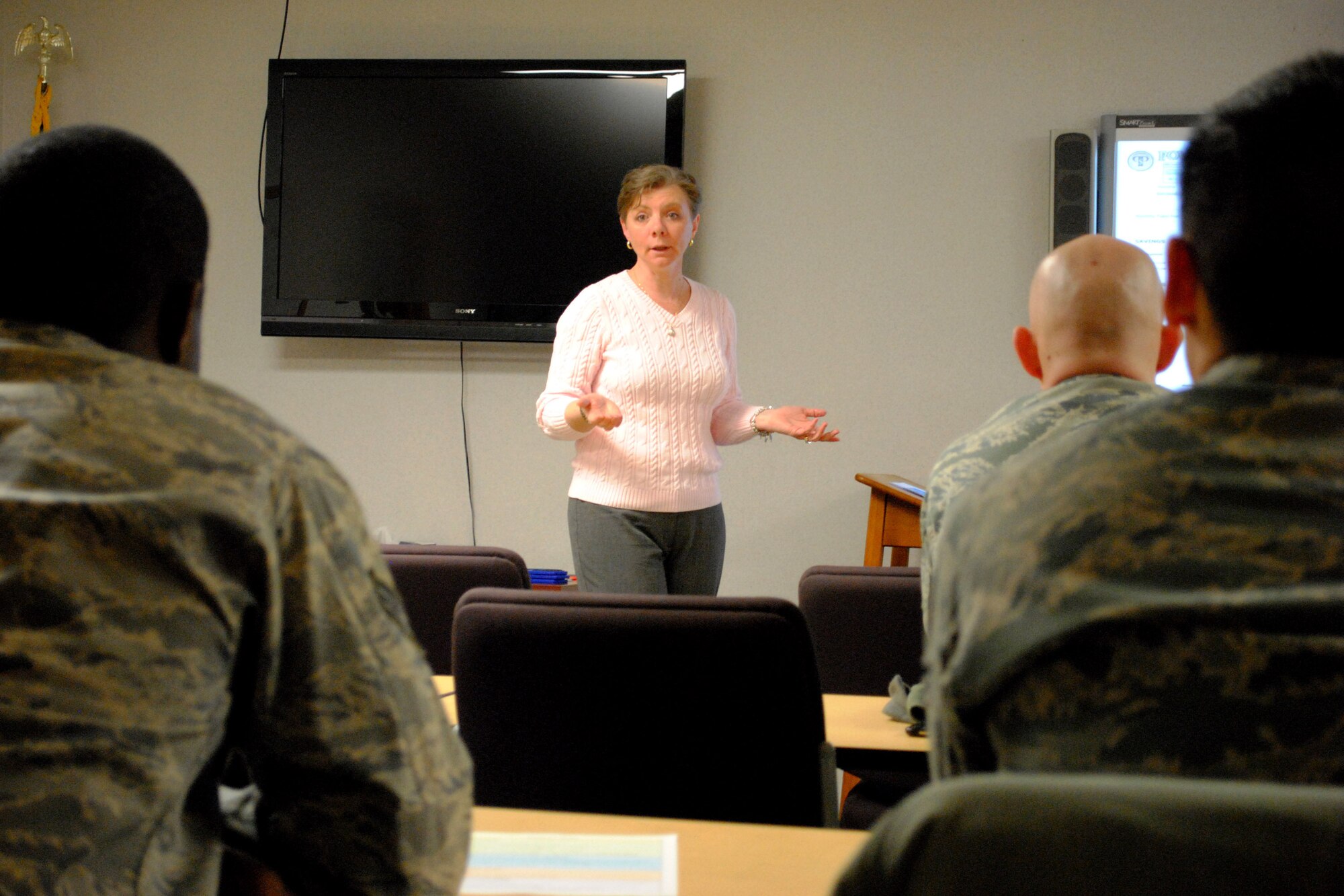 Airman listen to Becky Duncan explain one of the main advantages of creating a financial action plan during a Military Saves Week lunch and learn class held Feb. 24, 2014, at the Airman & Family Readiness Center on Grand Forks Air Force Base. N.D. Duncan, who holds a bachelor’s degree in marketing and a master’s degree in business management, taught a class focused on creating a financial action plan designed to motivate those in attendance to ask themselves the question—“What financial goal do you want to tackle this year?” (U.S. Air Force photo/Staff Sgt. Luis Loza Gutierrez) 
