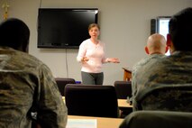 Airman listen to Becky Duncan explain one of the main advantages of creating a financial action plan during a Military Saves Week lunch and learn class held Feb. 24, 2014, at the Airman & Family Readiness Center on Grand Forks Air Force Base. N.D. Duncan, who holds a bachelor’s degree in marketing and a master’s degree in business management, taught a class focused on creating a financial action plan designed to motivate those in attendance to ask themselves the question—“What financial goal do you want to tackle this year?” (U.S. Air Force photo/Staff Sgt. Luis Loza Gutierrez) 
