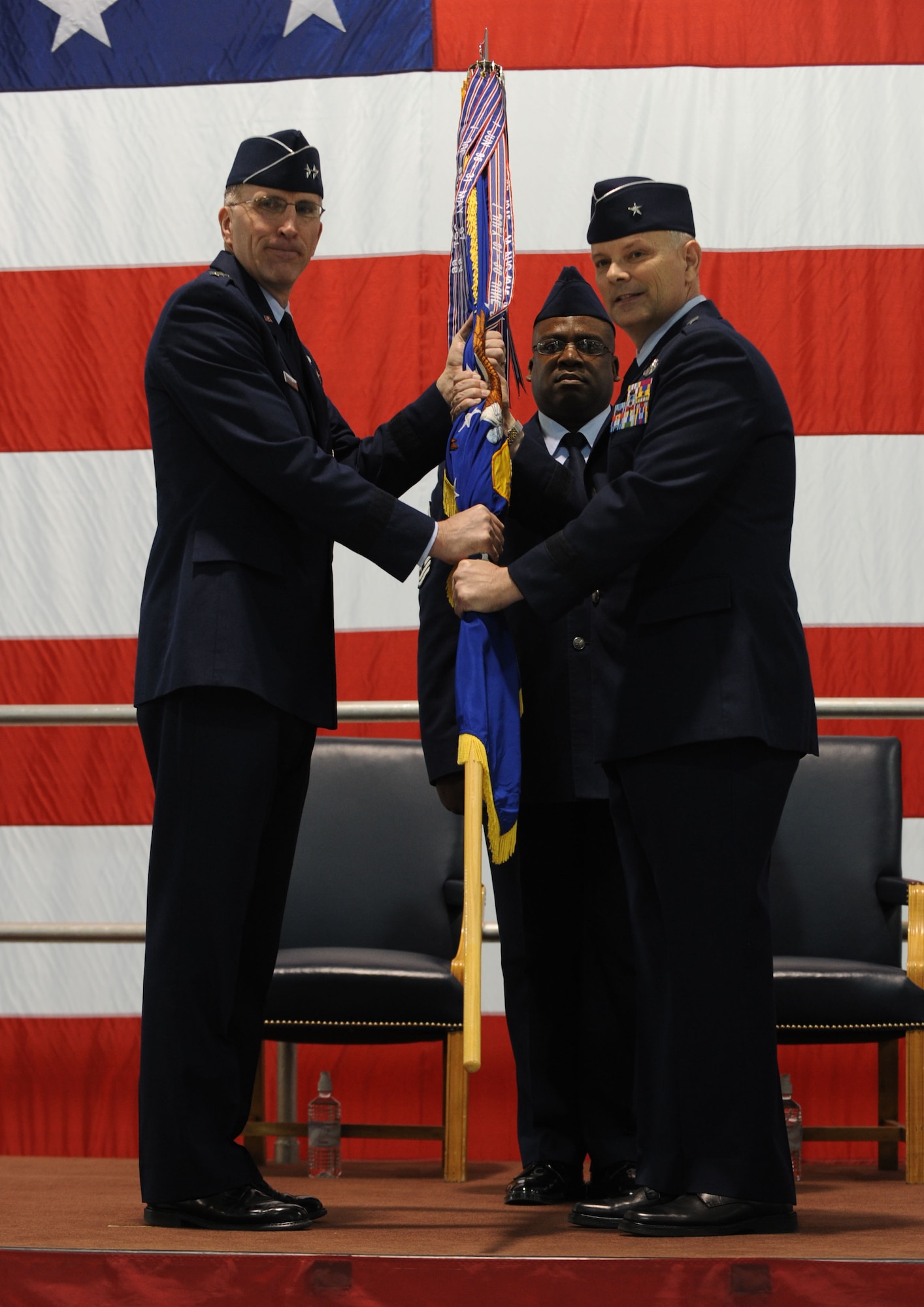Maj. Gen. Scott Vander Hamm, Eighth Air Force commander, hands over the wing guidon to Brig. Gen. Glen VanHerck, 509th Bomb Wing commander, during the change of command at Whiteman Air Force Base, Mo., Feb. 21, 2014. VanHerck is a Missouri native and University of Missouri graduate. (U.S. Air Force photo by Staff Sgt. Alexandra M. Boutte/Released)