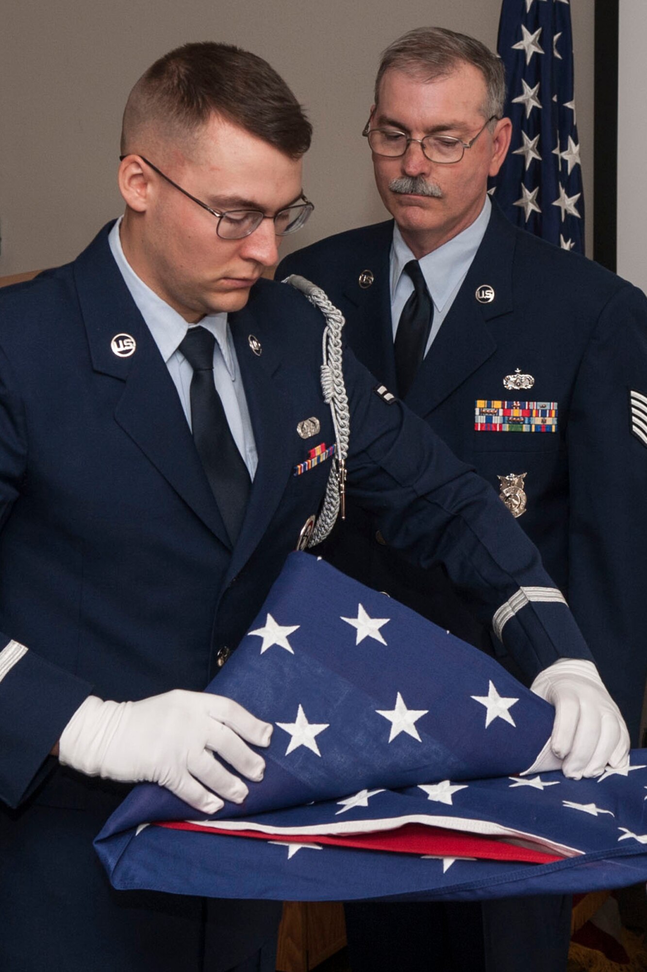 A Flag Folding ceremony is held during the retirement ceremony for U.S. Air Force Tech. Sgt. Richard McCune, Mar. 1, 2014, at Barksdale Air Force Base, La. McCune is a Fireman assigned to the 307th Fire Protection Flight and is retiring after serving more than 22 years. (U.S. Air Force photo by Master Sgt. Jeff Walston/Released)