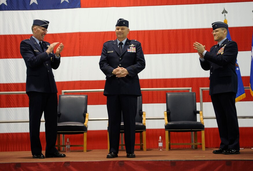 Maj. Gen. Scott Vander Hamm, Eighth Air Force commander, and the outgoing commander of the 509th Bomb Wing, Brig. Gen. Thomas Bussiere, congratulate the newest 509th BW commander, Brig. Gen. Glen VanHerck. VanHerck is the former commander of the 7th Bomb Wing at Dyess Air Force Base, Texas. (U.S. Air Force photo by Staff Sgt. Alexandra M. Boutte/Released)