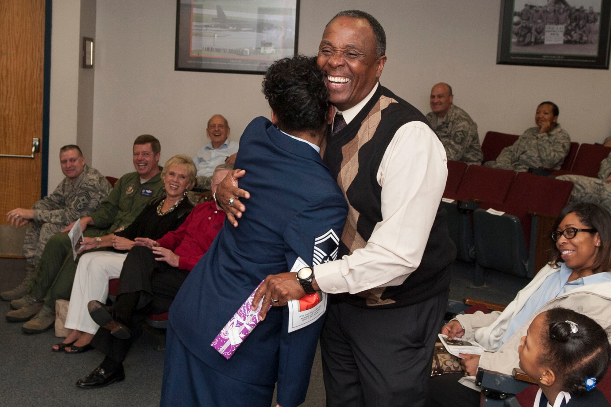 U.S. Air Force Senior Master Sgt. Laraine Warren-Dawn presents a gift to her husband Lee Dawn Jr. during a retirement ceremony on Mar. 1, 2014, Barksdale Air Force Base, La. Warren-Dawn is retiring from the Air Force Reserve after serving 34 years. (U.S. Air Force photo by Master Sgt. Jeff Walston/Released)