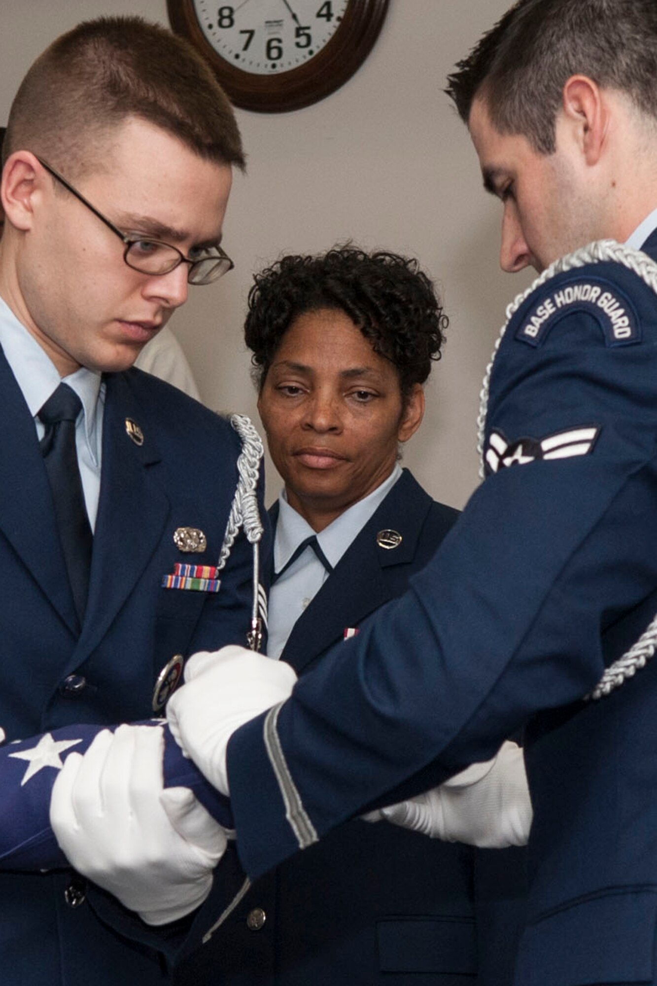U.S. Air Force Senior Master Sgt. Laraine Warren-Dawn looks on as members of the Base Honor Guard fold the American Flag during a retirement ceremony on Mar. 1, 2014, Barksdale Air Force Base, La. Warren-Dawn, the Superintendent assigned to the 307th Bomb Wing Services Flight is retiring after serving 34 years in the military. (U.S. Air Force photo by Master Sgt. Jeff Walston/Released)