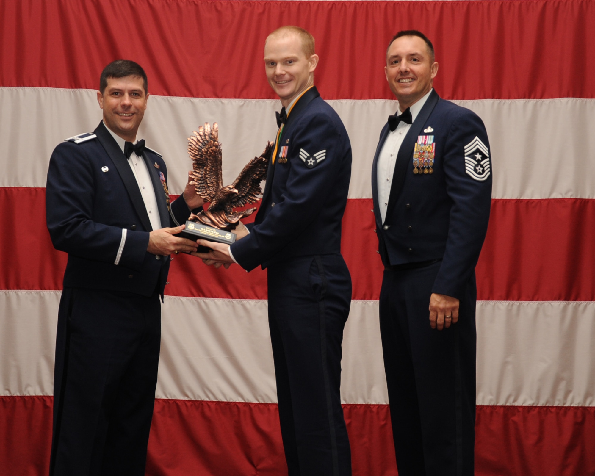 Senior Airman Scott Foss, Honor Guard, Bravo Flight, is presented Honor Guardsman of the Year award during the Annual Awards ceremony at Hoban Hall on Barksdale Air Force Base, La., Feb. 20, 2014. (U.S. Air Force photo/Staff Sgt Sean Martin)
