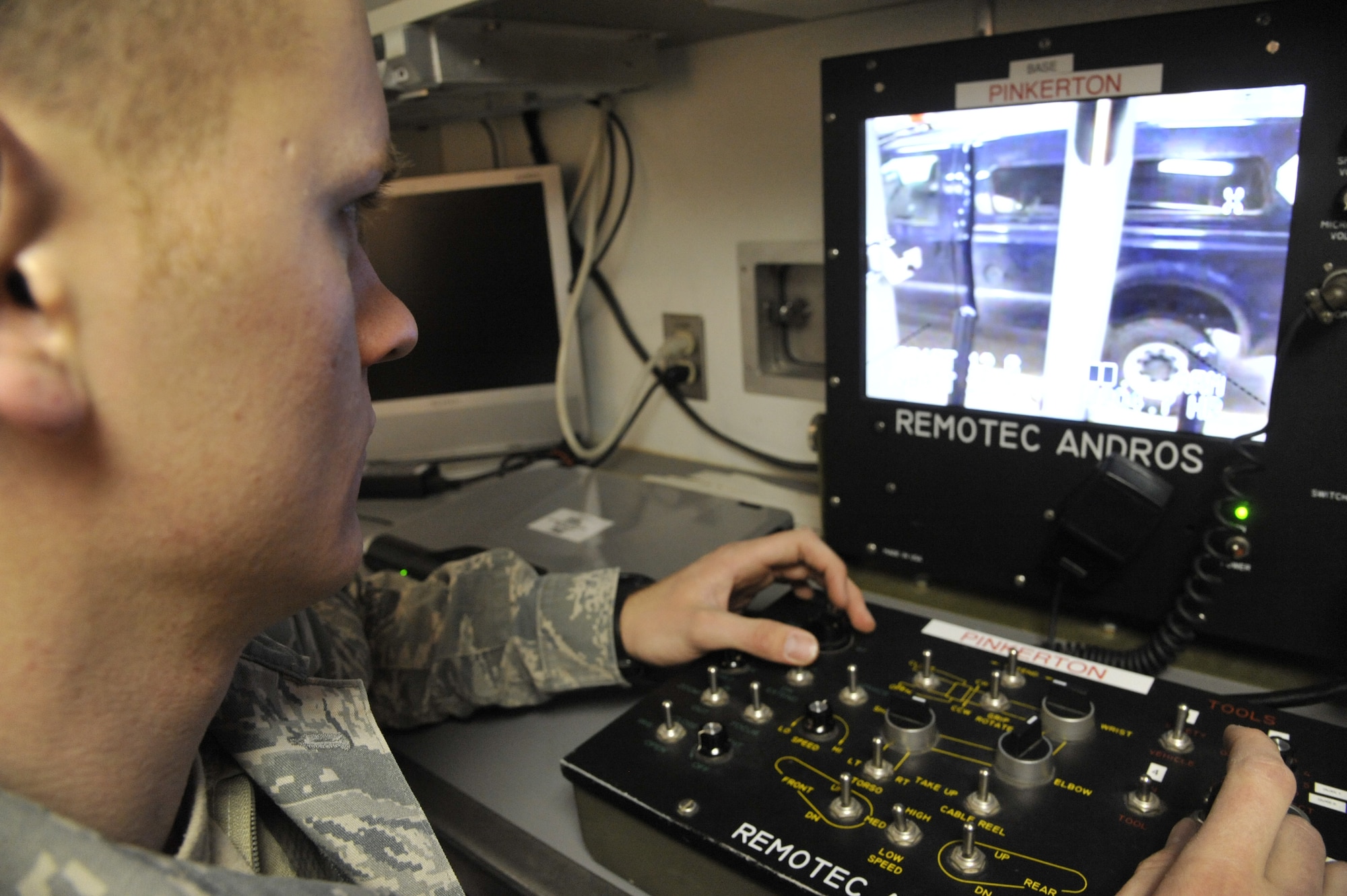 Airman 1st Class Ryan Carel, 509th Civil Engineer Squadron explosive ordnance disposal team member, controls an F6A robot using the control station at Whiteman Air Force Base, Mo., Feb. 11, 2014. This device operates robots to handle explosives,
eliminating direct human interaction with the explosive device. (U.S. Air Force photo by Airman 1st Class Keenan Berry/Released)