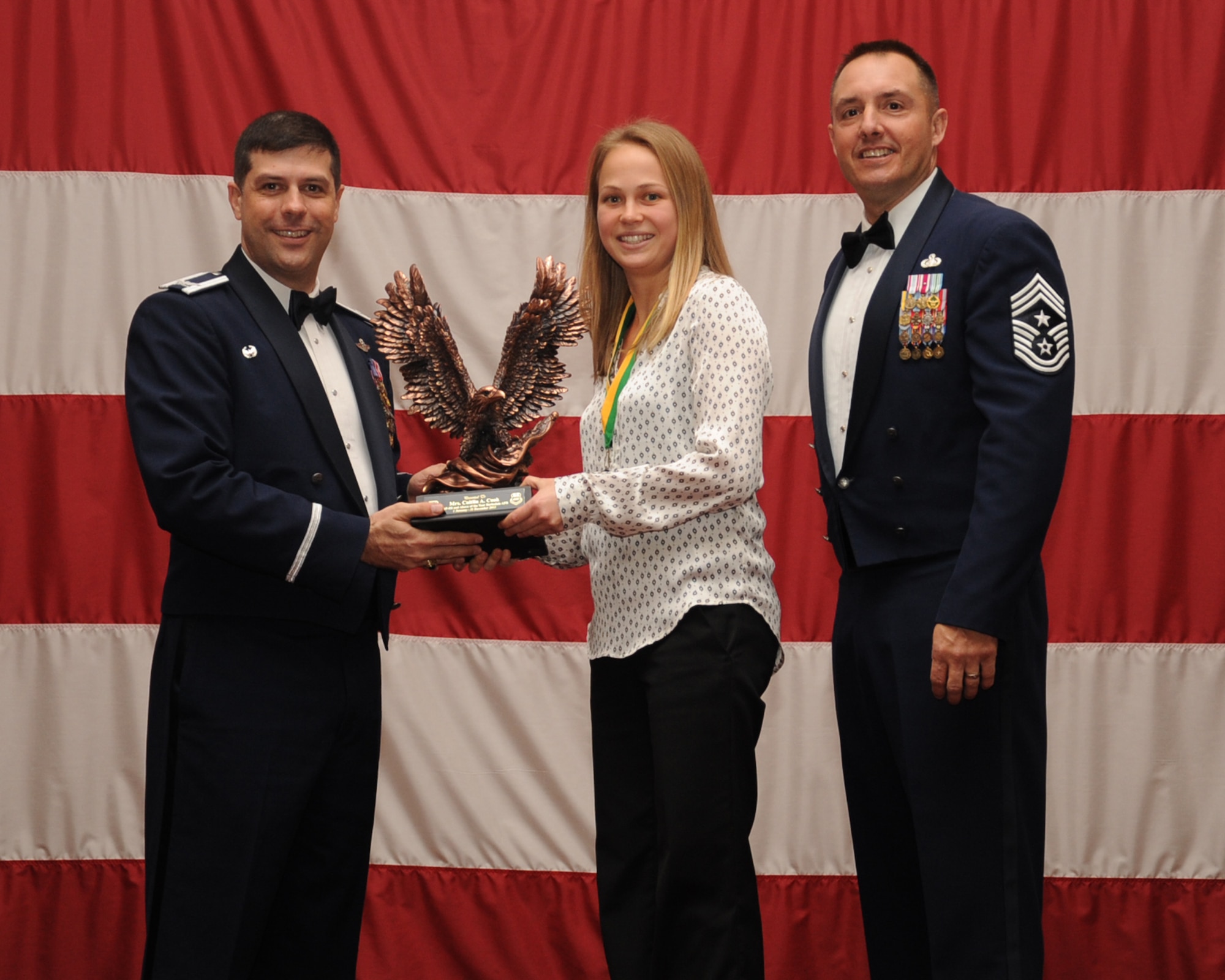 Caitlin Cook, 2nd Force Support Squadron, is presented the Category 3, NF 3 and above Civilian of the Year award during the Annual Awards ceremony at Hoban Hall on Barksdale Air Force Base, La., Feb. 20, 2014. (U.S. Air Force photo/Staff Sgt Sean Martin)
