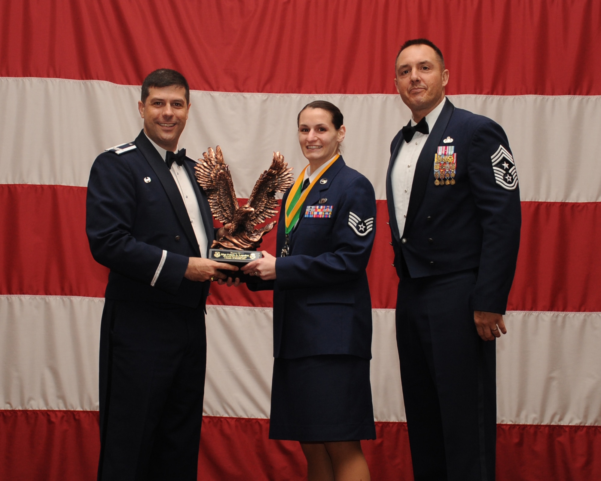 Staff Sgt. Felicia Logsdon, 2nd Comptroller Squadron, is presented the Non-Commissioned Officer of the Year award during the Annual Awards ceremony at Hoban Hall on Barksdale Air Force Base, La., Feb. 20, 2014. (U.S. Air Force photo/Staff Sgt Sean Martin)
