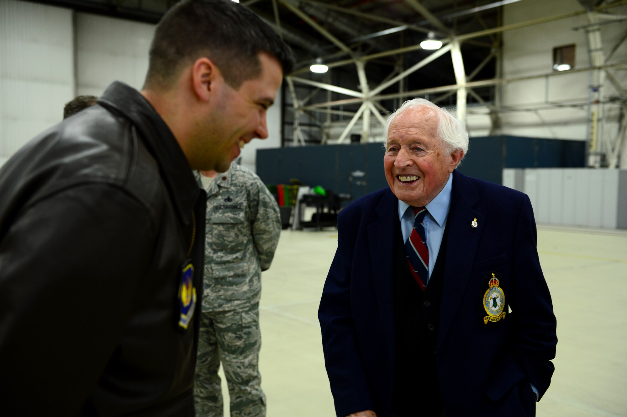 Capt. Scott Leibbrandt, 492nd Fighter Squadron pilot, shares a laugh with Ron Brown, former Royal Air Force Wellington Bomber crew member, at RAF Lakenheath, England, Feb. 28, 2014. The World War II pilot visited RAFs Feltwell and Lakenheath to tour the bases and learn about the mission of the 48th Fighter Wing. (U.S. Air Force photo by Airman 1st Class Dawn M. Weber/Released)