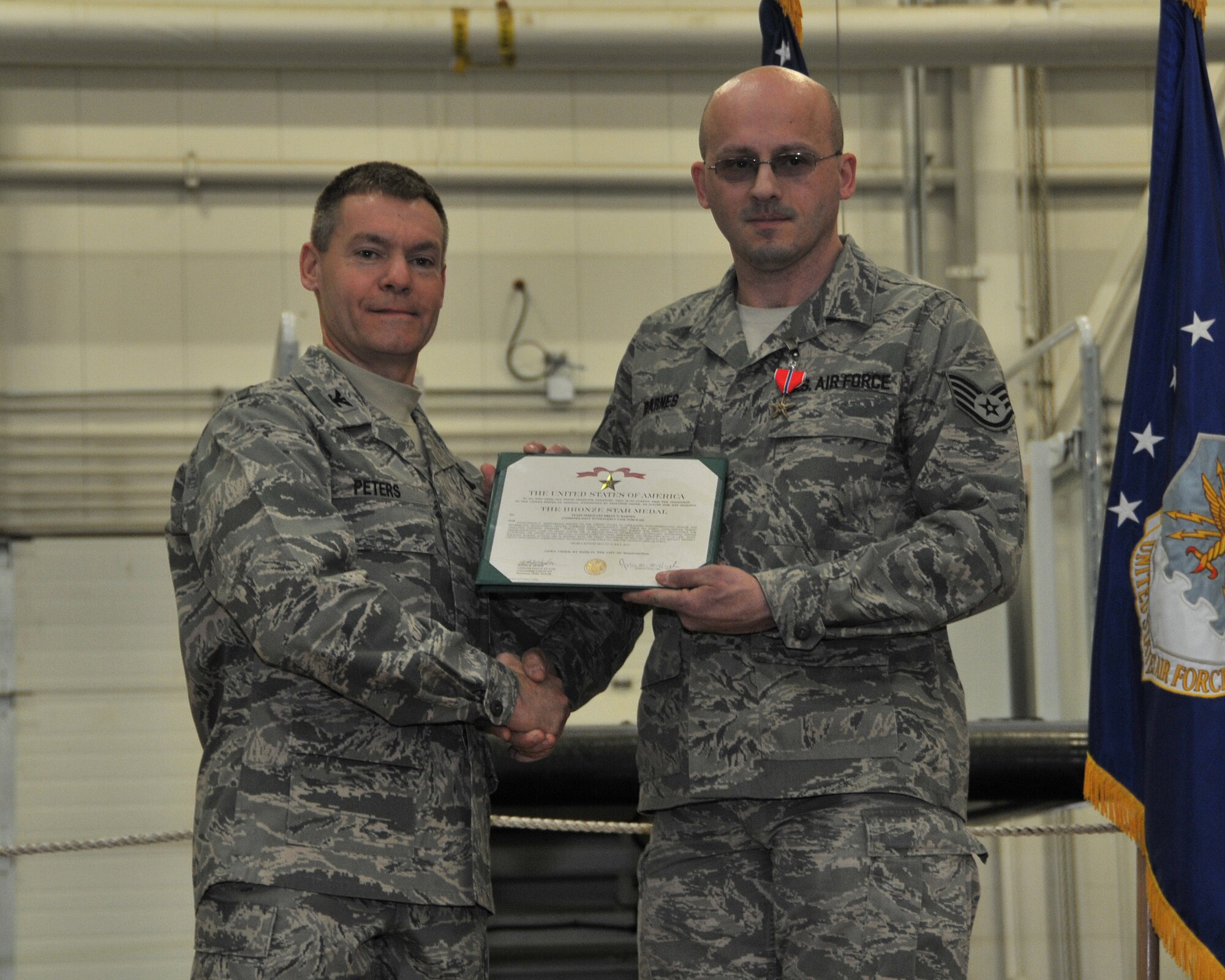 Col. Craig C. Peters, 911th Airlift Wing Commander, presents the Bronze Star Medal to Brian N. Barnes, a computer systems operator, 911th Communications Squadron, during a commander’s call at the Pittsburgh International Airport Air Reserve Station, February 8, 2014. Staff Sgt. Barnes was awarded the BSM for his meritorious service performed as an operations noncommissioned officer and information management officer with Combined Joint Interagency Task Force 435 in Kabul, Afghanistan from August 6, 2012 to July 31, 2013. (U.S. Air Force photo by Senior Airman Joshua J. Seybert)
