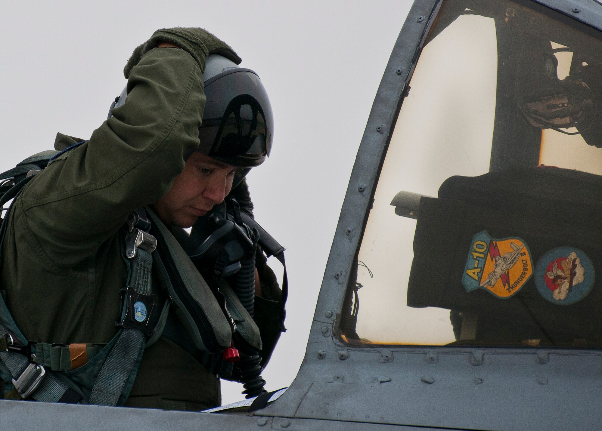 As fog rolls in, a 355th Fighter Wing pilot adjusts his helmet while waiting in his A-10 Thunderbolt II for a morning Weapon System Evaluation Program sortie at Eglin Air Force Base, Fla., Feb. 19.  The A-10s from Davis-Monthan Air Force Base, Ariz., participated in the week-long mission known as Combat Hammer, in which they released air-to-ground munitions.  The Combat Hammer WSEP program is managed by the 86th Fighter Weapons Squadron, part of the 53rd Wing.  (U.S. Air Force photo/Samuel King Jr.)