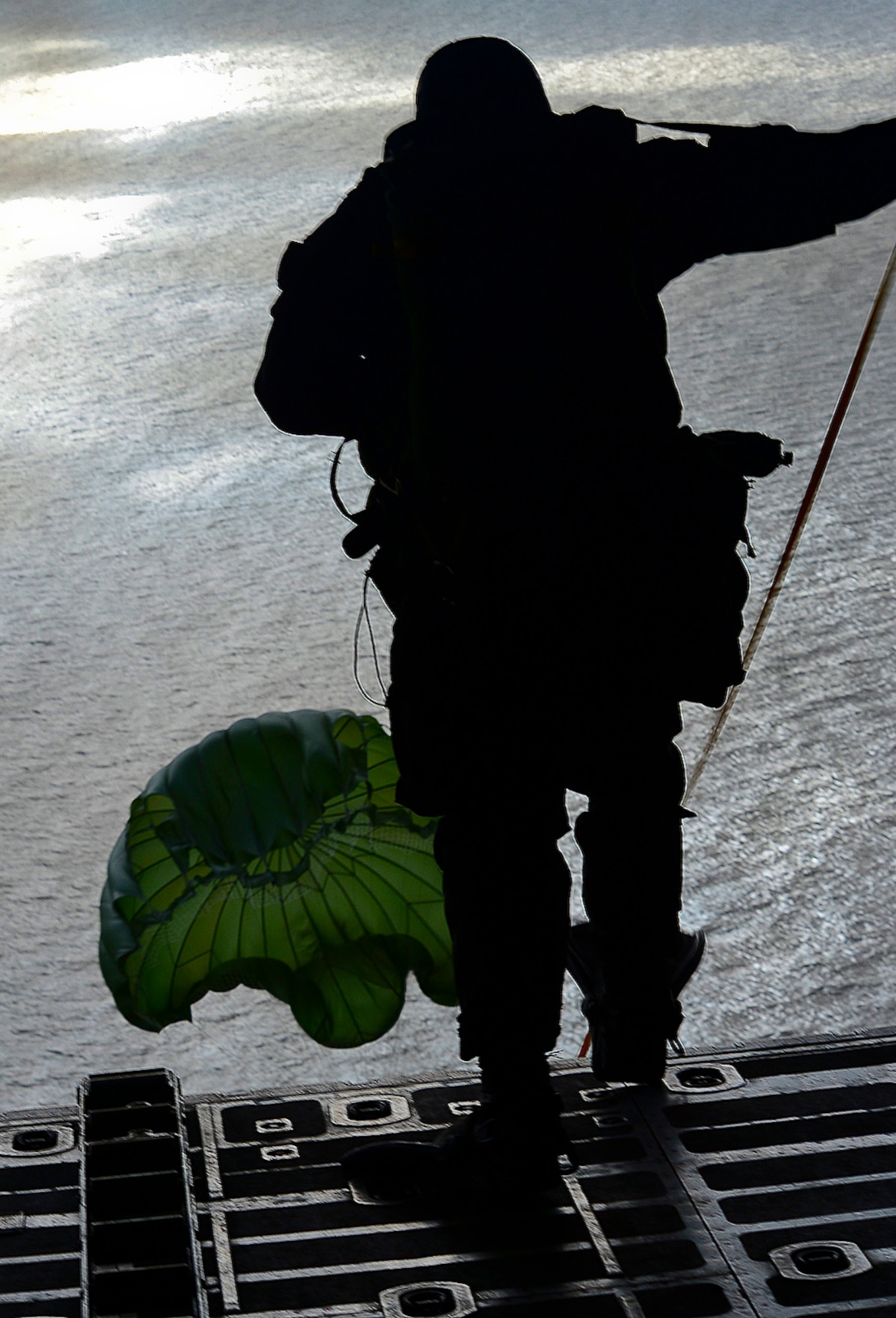 A pararescue specialist from the 56th Rescue Squadron jumps from a MC-130H Combat Talon II based out of Royal Air Force Mildenhall, England, during combat search and rescue training off the coast of Felixstowe, Feb. 25, 2014. Pararescue jumpers go through intense training to be effective in search and rescue operations. Static line jumps allow PJs to jump from aircraft at lower altitudes. (U.S. Air Force photo by Airman 1st Class Dana J. Butler/Released)