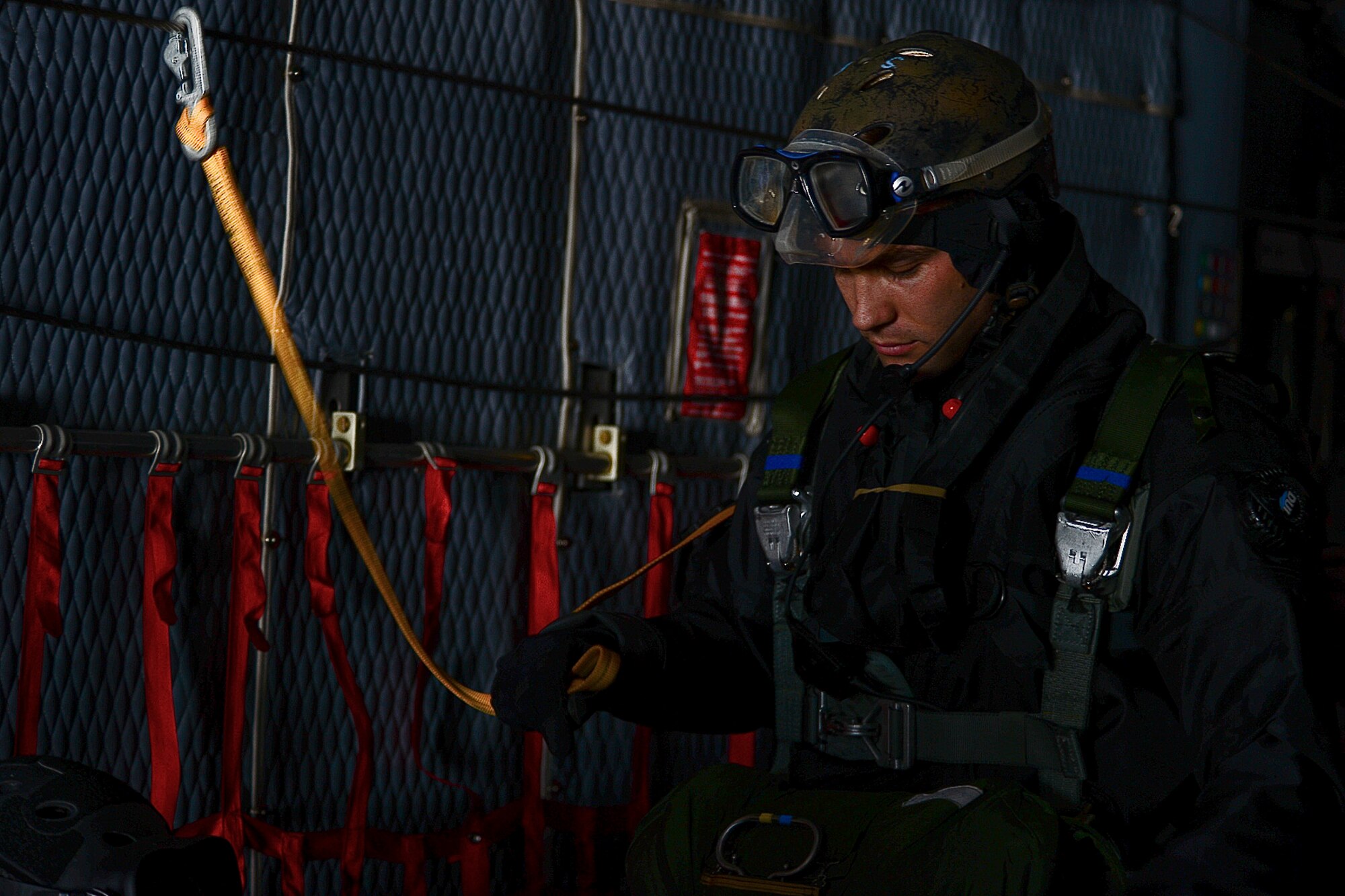 Staff Sgt. Cody Cerny, 56th Rescue Squadron pararescue speacialist, prepares for a static-line parachute jump during combat search and rescue training off the coast of Felixstowe, England, Feb. 25, 2014. Pararescuemen or PJs, go through intense training to be effective in search and rescue operations. Static line jumps allow PJs to jump from aircraft at lower altitudes. (U.S. Air Force photo by Airman 1st Class Dana J. Butler/Released)