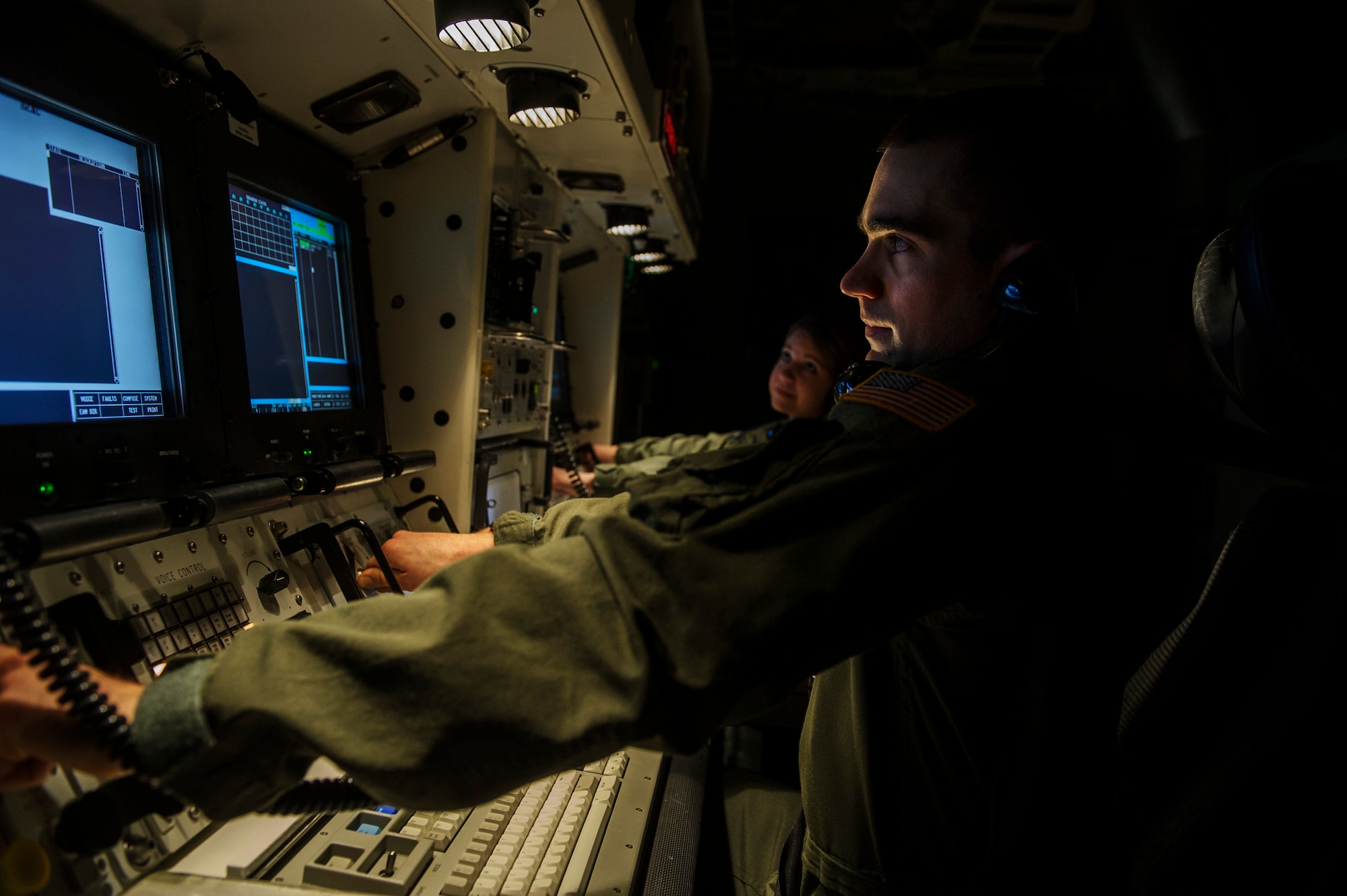 Capt. Robert Shannon and Capt. Brooke Lake, 341st Operations Support Squadron missile operators, goes through a launch procedure checklist during simulation training at Malmstrom Air Force Base, Mont., Feb. 6, 2014. (U.S. Air Force photo by Staff Sgt. Jonathan Snyder/RELEASED)