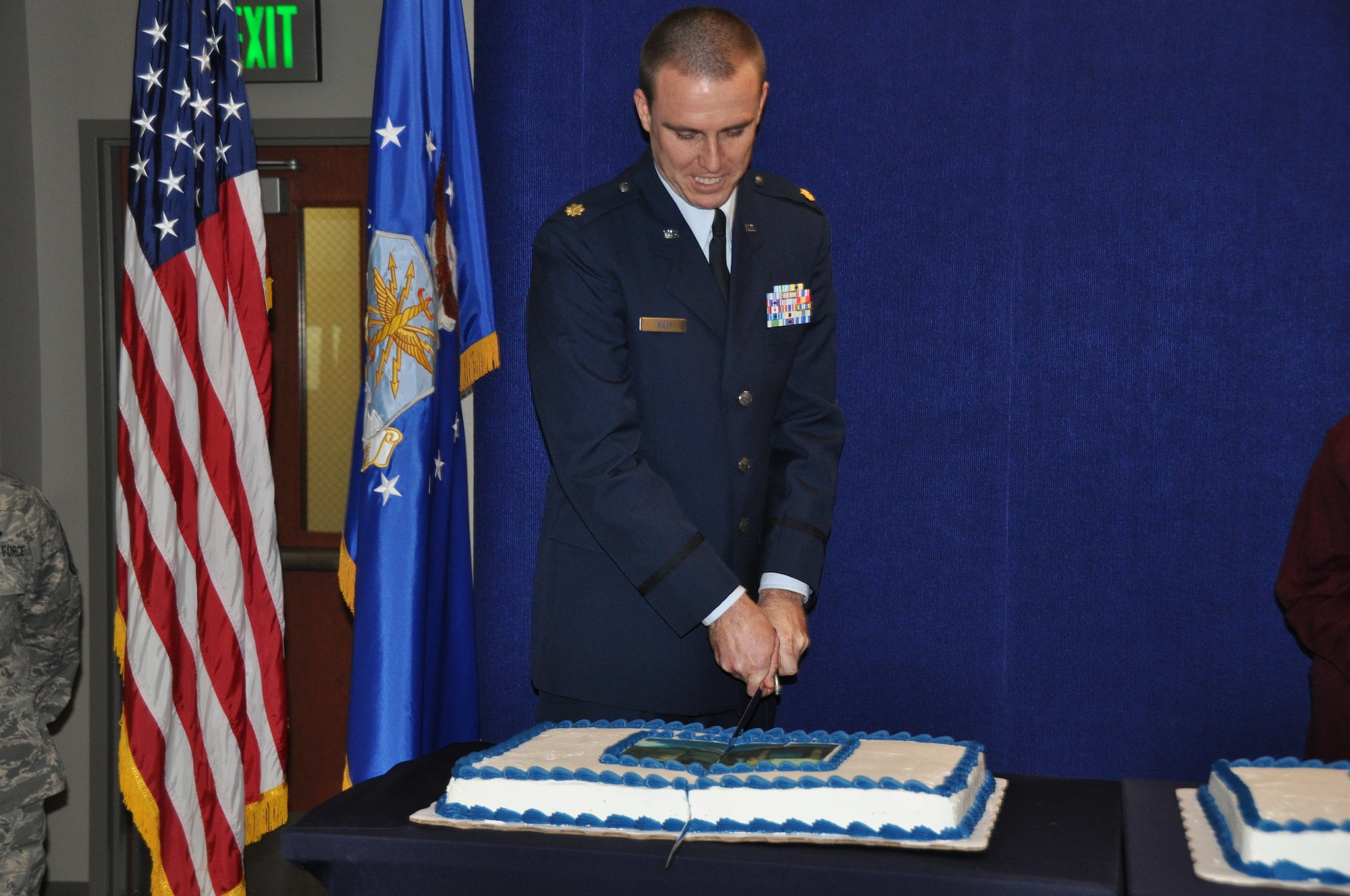 Maj. Ryan Avery, Air Reserve Personnel Center assignment facilitator, cuts the ceremonial cake representing the ARPC's location at Buckley Air Force Base during a briefing highlighting ARPC’s 60th anniversary Feb. 28, 2014, on Buckley Air Force Base, Colo. More than 150 people attended the event open to all current and former ARPC employees, Buckley AFB leadership and community partners highlighting ARPC’s history and advancement in technology, policies and procedures of six decades and historic memorabilia on display for everyone to see. (U.S. Air Force photo/Tech. Sgt. Rob Hazelett)