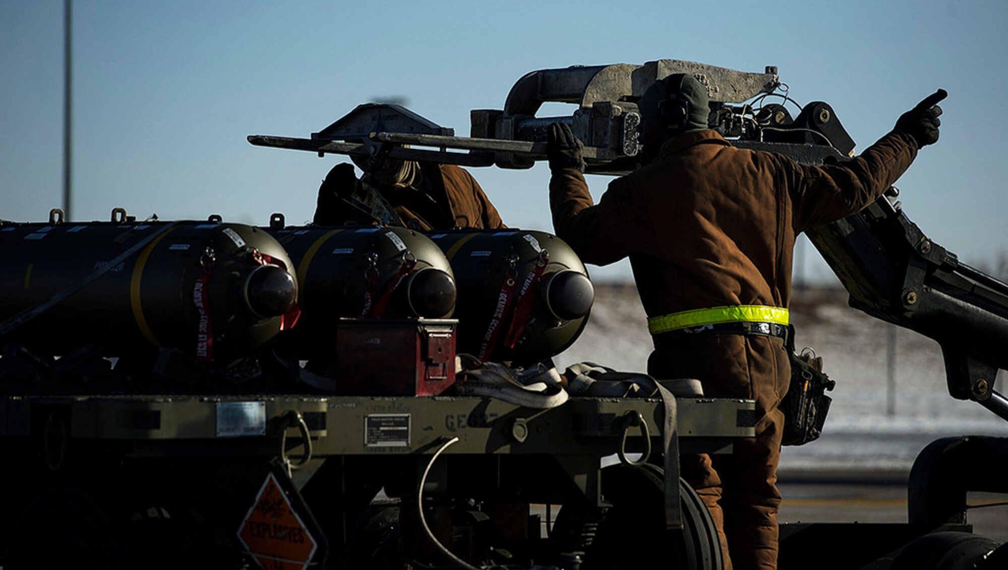 Senior Airman Steven Fisher and Staff Sgt. Terry White, 5th Aircraft Maintenance Squadron weapons load crew members, prepare to move a Cluster Bomb Unit 103 at Minot Air Force Base, N.D., Feb. 10, 2014. B-52H Stratofortress weapons loaders are trained and certified to load a variety of nuclear and conventional munitions in support of combatant commander requirements. (U.S. Air Force photo by Staff Sgt. Jonathan Snyder/RELEASED)