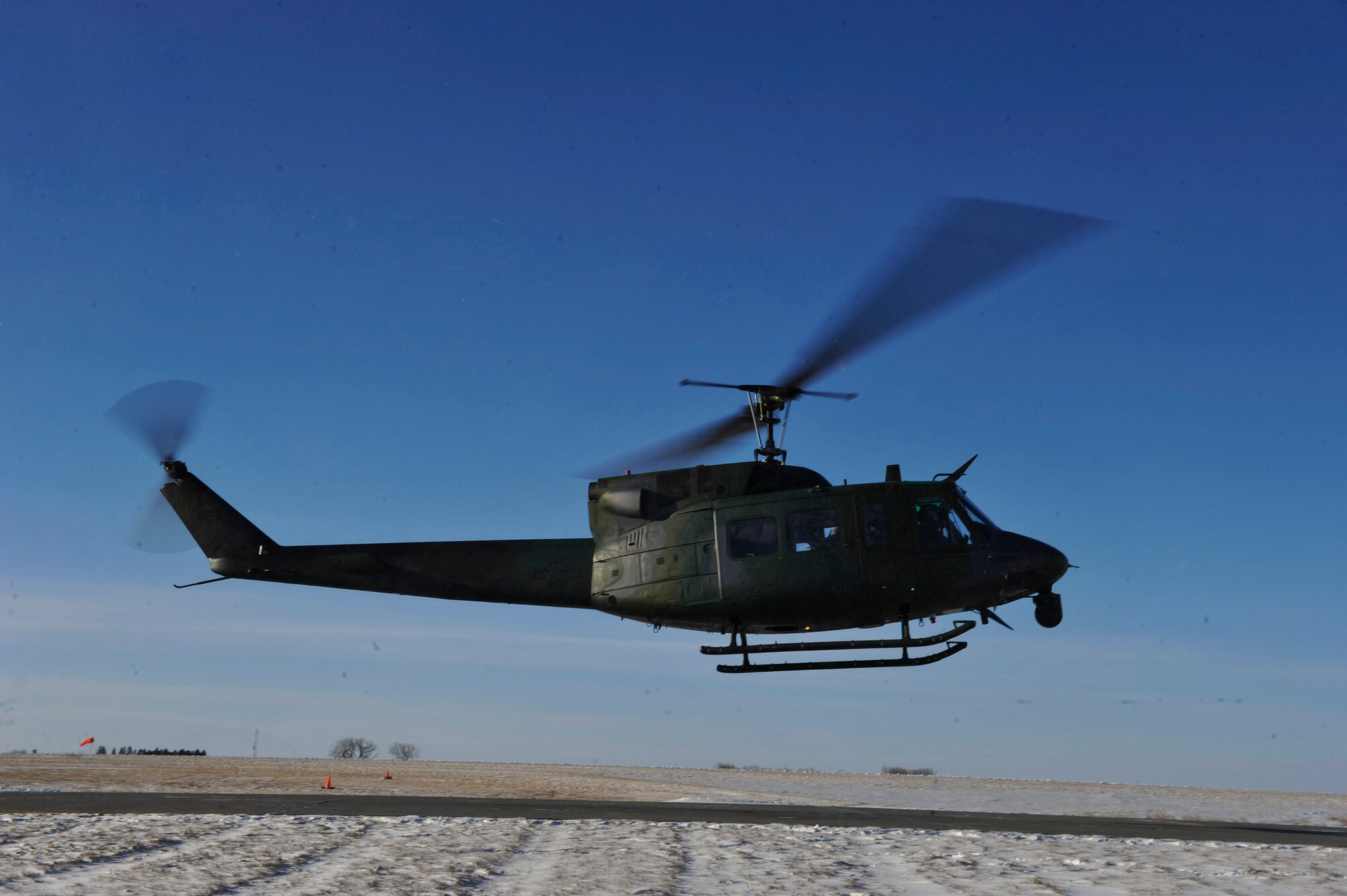 A 54th Helicopter Squadron UH-1N Huey takes off for a training mission at Minot Air Force Base, N.D., Feb. 13, 2014. (U.S. Air Force photo by Staff Sgt. Jonathan Snyder/RELEASED)