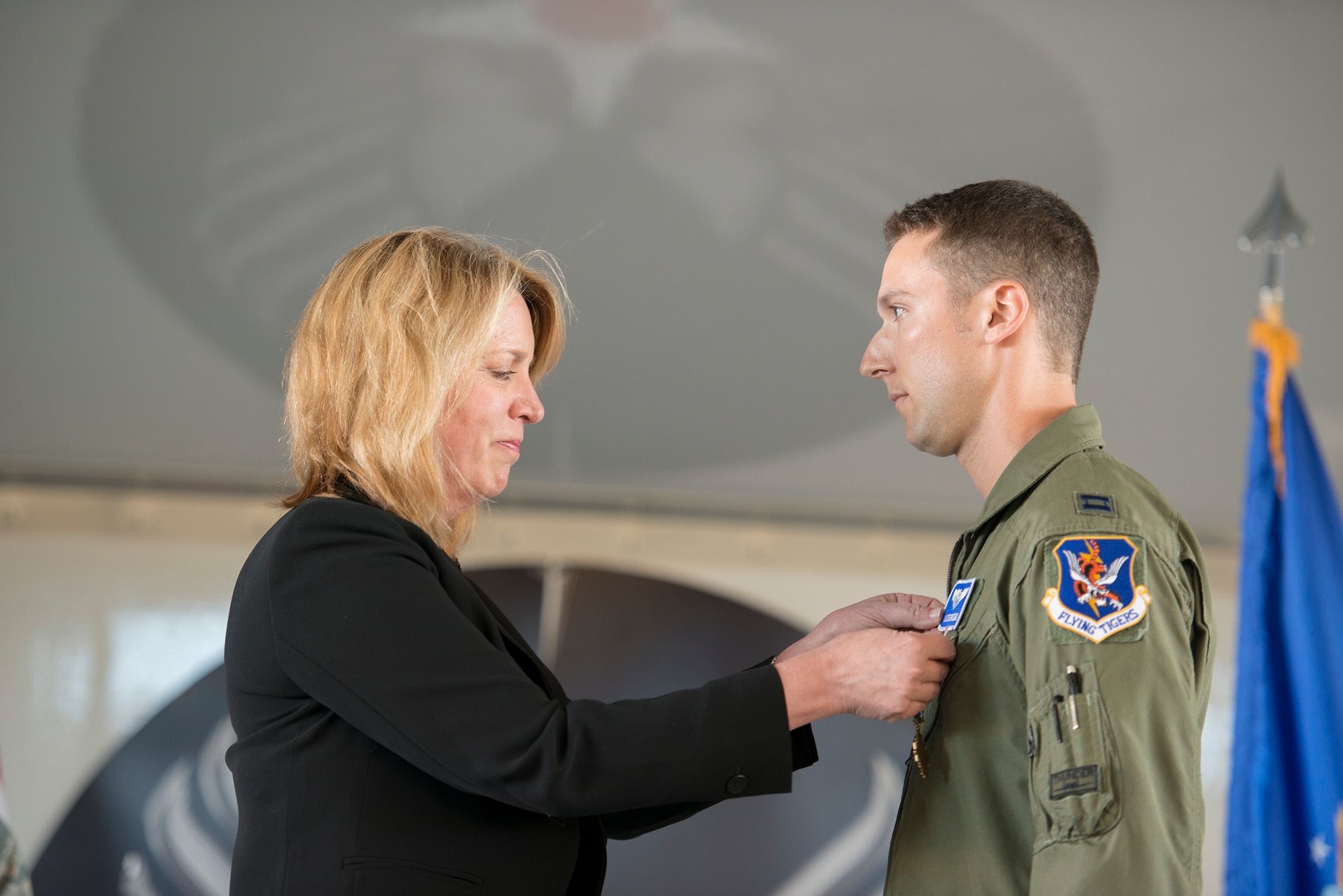 Secretary of the Air Force Deborah Lee James pins the Distinguished Flying Cross on Capt. Ian Osterreicher, A-10C Thunderbolt II pilot with the 74th Fighter Squadron, during an all call at Moody Air Force Base, Ga., Feb. 28, 2014. Osterreicher was awarded the DFC for his actions in Afghanistan, which saved the lives of at least 60 American soldiers. (U.S. Air Force photo by Airman 1st Class Ryan Callaghan/Released)
