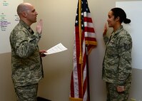 WRIGHT-PATTERSON AIR FORCE BASE, Ohio - Maj. Kent Shea, 445th Force Support Squadron commander, administers the Oath of Enlistment to Tech. Sgt. Shatasha Estes, 445th FSS knowledge operations craftsman, during her re-enlistment ceremony Feb. 9. (U.S. Air Force photo/Staff Sgt. Mikhail Berlin)