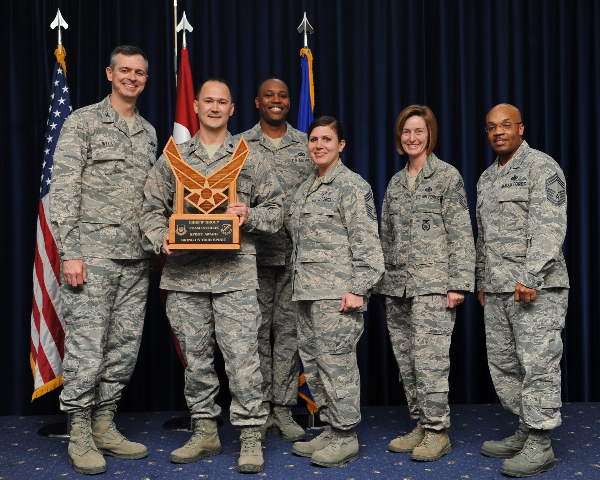 Lt. Col. James Skelton, 39th Communications Squadron commander, center, accepts the Chief's Spirit Award on behalf of the 39th CS during the promotion ceremony Feb. 28, 2014, Incirlik Air Base, Turkey. The award is presented to the squadron that displays the most squadron "spirit" during the ceremony. (U.S. Air Force photo by Senior Airman Chase Hedrick/Released)