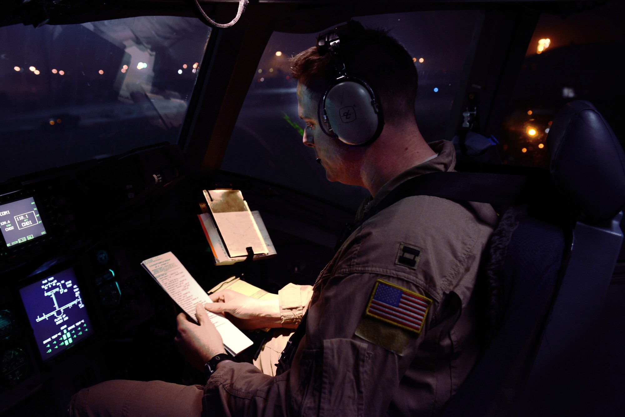 Capt. Daniel Boone, 817th Expeditionary Airlift Squadron, Detachment 1, instructor pilot, sits in the co-pilot position during the last airlift mission out of the Transit Center at Manas, Kyrgyzstan, March 3, 2014. The flight signified the unofficial end to the fourth and final mission pillar here, airlift. With the end of support operations for Afghanistan at the TCM, future airlift missions will be dedicated to the center?s closure. Boone is deployed from Charleston Air Force Base, S.C.   (U.S. Air Force photo/Staff Sgt. Travis Edwards)