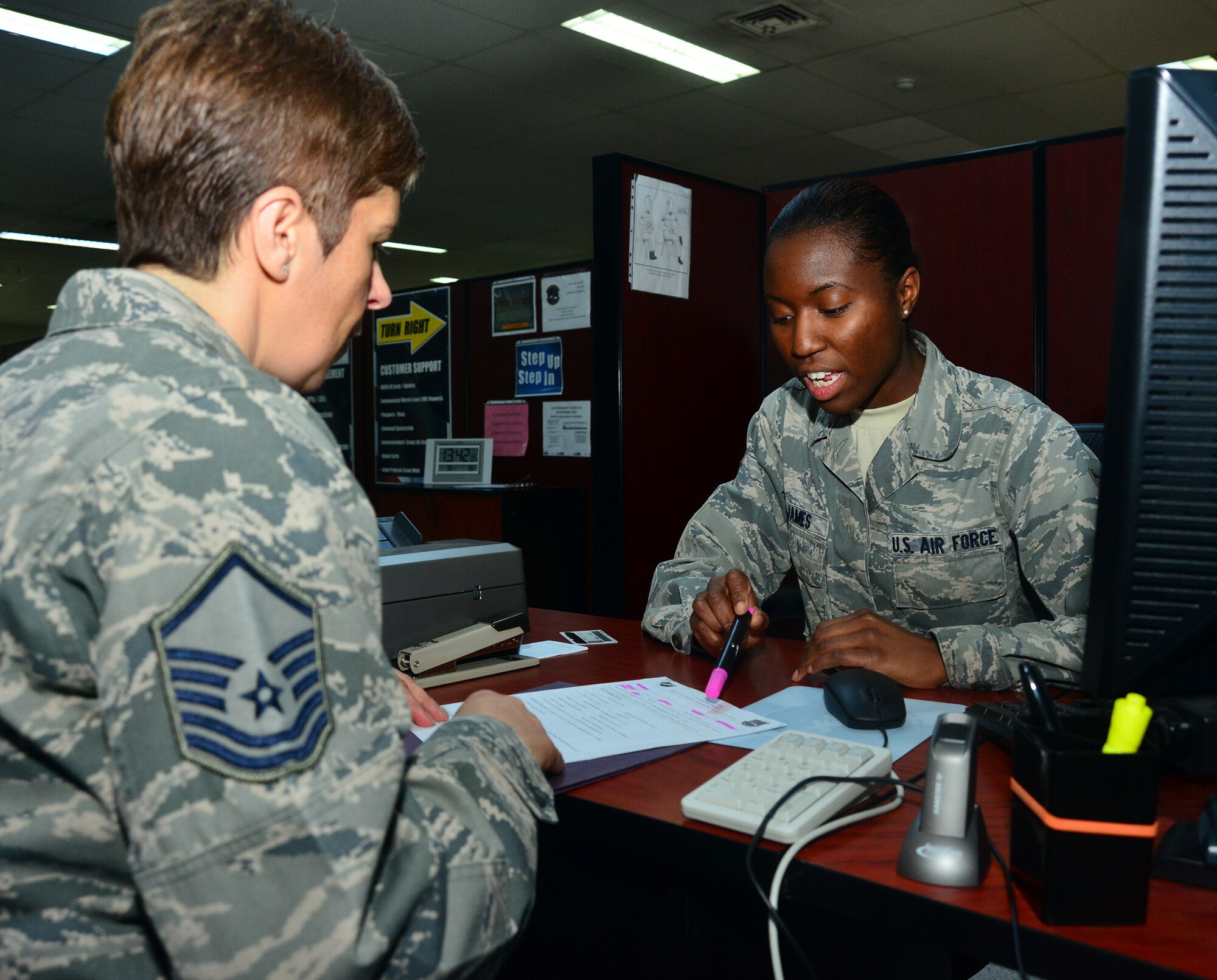 Senior Airman Juanita James, 39 Force Support Squadron personnelist, reviews the in-processing checklist with a customer who recently arrived to the 39th Air Base Wing, March 3, 2014, at Incirlik Air Base, Turkey. The checklist is part of new streamlined process that helps members expeditiously in-process at Incirlik AB. (U.S. Air Force photo by Staff Sgt. Eric Summers Jr./Released) 