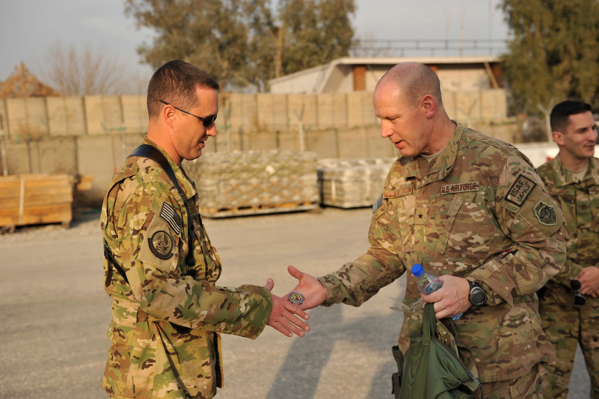 U.S. Air Force Technical Sgt. Jason Ruddell is coined for his outstanding performance by Brig. Gen. Patrick Malackowski, 455th Air Expeditionary Wing commander, at Jalalabad Airfield, Afghanistan, Feb. 25, 2014. Malackowski spent the day talking to airmen at Jalalabad and recognizing outstanding performers there.(U.S. Air Force photo by Senior Master Sgt. Gary J. Rihn/Released)