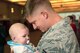 Airman 1st Class Chase Kenimer, fire team member for the Wis. Air National Guard's 115th Fighter Wing Security Forces Squadron meets his niece for the very first time upon returning to Dane County Regional Airport  Mar. 2. Twenty six members of the Wing's Security Forces Squadron spent six months deployed in support of Operation Enduring Freedom/Combined Joint Task Force-Horn of Africa and secured 3,500 personnel and $7.2 billion worth of assets within their area of responsibility. (Air National Guard photo by Master Sgt. Paul Gorman)