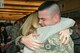 Staff Sgt. Justin Padley, fire team member for the Wis. Air National Guard's 115th Fighter Wing Security Forces Squadron embraces his soon-to-be fiancée Wendy Anderson upon returning to Dane County Regional Airport  Mar. 2. Twenty six members of the Wing's Security Forces Squadron spent six months deployed in support of Operation Enduring Freedom/Combined Joint Task Force-Horn of Africa and secured 3,500 personnel and $7.2 billion worth of assets within their area of responsibility. (Air National Guard photo by Master Sgt. Paul Gorman)