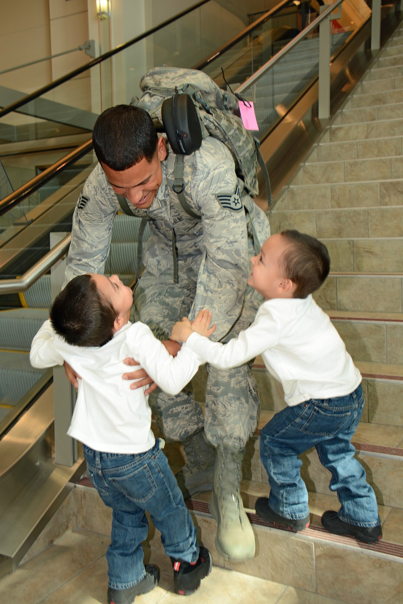 Staff Sgt. Nathan Ortiz, fire team member for the Wis. Air National Guard's 115th Fighter Wing Security Forces Squadron returns to Dane County Regional Airport in Madison, Wis. March 2, where he is reunited with his sons Jowell and Jariel for the first time in over six months. Twenty six members of the Wing's Security Forces Squadron deployed in support of Operation Enduring Freedom/Combined Joint Task Force-Horn of Africa and secured 3,500 personnel and $7.2 billion worth of assets within their area of responsibility. (Air National Guard photo by Master Sgt. Paul Gorman)