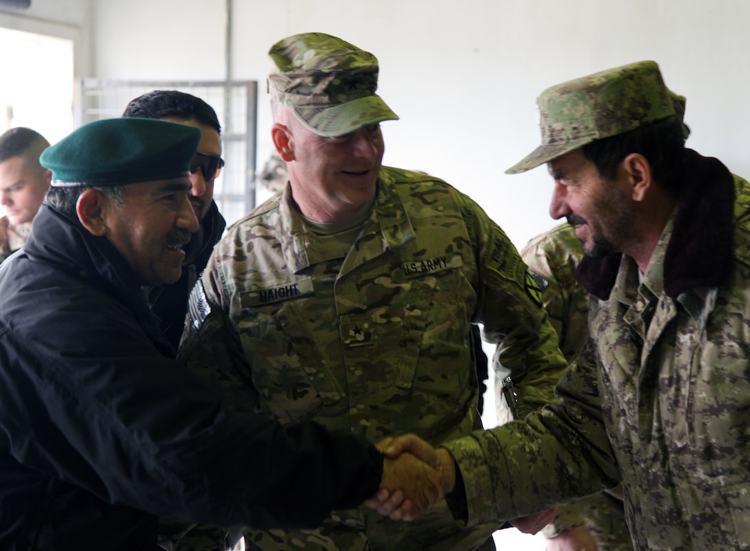 U.S. Army Brig. Gen. David Haight, center, and Afghan national army Maj. Gen. Mohammad Yaftali greet an Afghan soldier on Forward Operating Base Thunder in Afghanistan's Paktia province, March 3, 2014. The soldiers participated in a combined arms rehearsal. Haight is assigned to the 10th Mountain Division and Yaftali is commanding general of the 203rd Corps. 