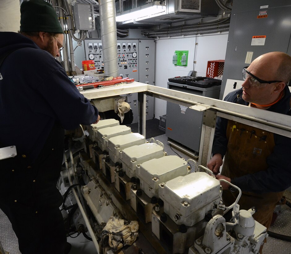 Jon Miller (left) and Jon Ledford, both assistant engineers for the district’s service fleet,  work one of the two, 300 kilowatt diesel-generators for the Quarters Boat Taggatz. The winter months provides the perfect time to perform preventive maintenance on the district’s fleet and equipment. The Quarters Boat Harold E. Taggatz is one of three vessels that make up the St. Paul District’s dredging fleet and is used to house those working on the dredging crew.