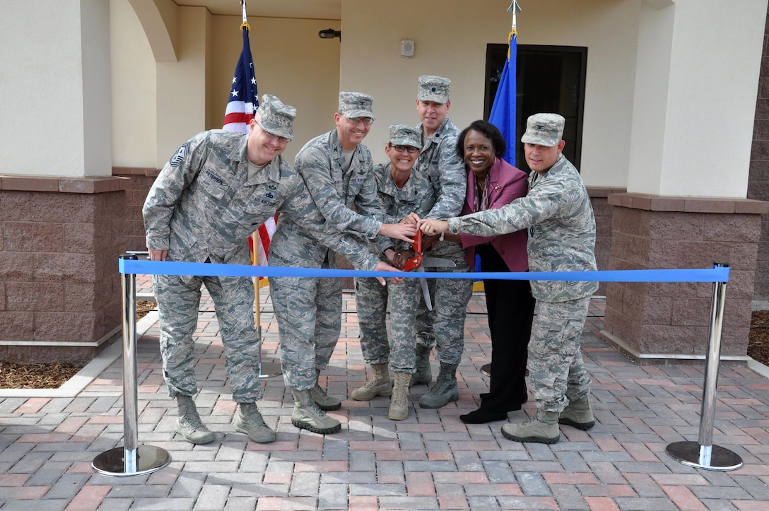 Officials ceremonially cut the ribbon officially opening the Vandenberg Air Force Base education Center Feb. 27. (L to R) Cutting the ribbon are: Chief Master Sgt. Ryan Petersen, 30th Space Wing command chief; Col. Keith Balts, 30th Space Wing commander; Col. Kim Colloton, U.S. Army Corps of Engineers Los Angeles District commander; Lt. Col. Gregory Marty, 30th Force Support Squadron commander; Barbara Bennie, Force Development flight chief; and Col. Brent McArthur, 30th Space Wing vice commander.   