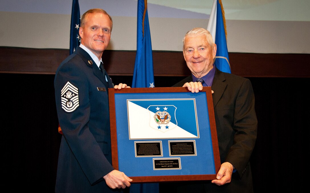 Maxwell Air Force Base, Ala. - Chief Master Sergeant of the Air Force James A. Cody, presents the CMSAF positional colors, to retired Chief Master Sergeant Robert D. Gaylor, fifth CMSAF, at the Air Force Senior Noncommissioned Officer Academy, Thursday, Feb. 27, 2014. Airmen from Maxwell gathered to honor the former Chief Master Sergeants and surviving family members during the ceremony. (USAF photo by Donna L. Burnett/Released)