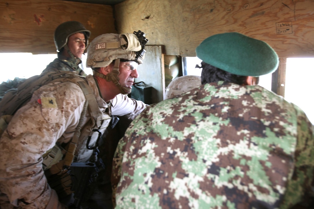 Colonel Christopher Douglas, a reservist from Ballston Spa, N.Y., and the team leader of Security Force Assistance Advisor Team 2-215, looks out over the Sangin Valley from an outpost located near Forward Operating Base Robinson, Feb. 24, 2014. Colonel AbdulHai Neshat, the executive officer of 2nd Brigade, 215th Corps, Afghan National Army, invited Douglas to visit outposts and see the progress made during a recent operation, Oqab 144.