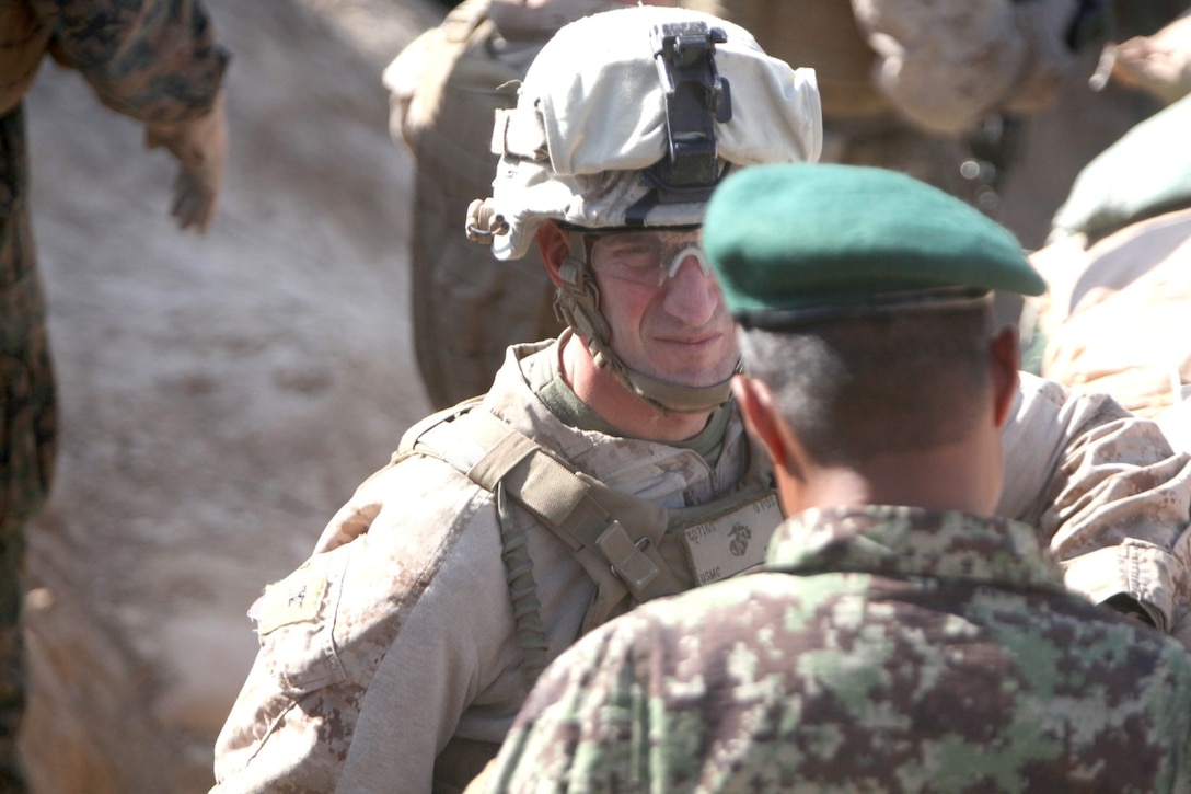 Colonel Christopher Douglas, the team leader of Security Force Assistance Advisor Team 2-215 speaks to Col. AbdulHai Neshat, the executive officer of 2nd Brigade, 215th Corps, Afghan National Army, on an outpost near Forward Operating Base Robinson, Feb. 24, 2014. Douglas, a reservist from Ballston Spa, N.Y., and Neshat meet frequently to discuss the future of the Sangin Valley.