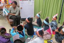 Elizabeth Jackson, an employee in Huntsville Center's Installation Support and Programs Management Directorate, reads to University Place Elementary students March 3.