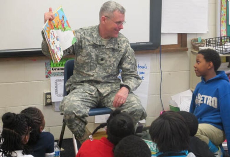 Lt. Col. William Burruss, deputy commander, Huntsville Center, reads to Highlands Elementary students March 3.