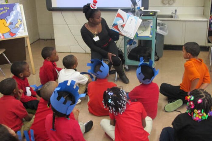 Jerrica Thompson, an employee in Huntsville Center's Resource Management Directorate, reads to Highlands Elementary School students March 3.