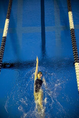 Danielle Piper, 12, swims in a 50-meter back stroke race at a swim meet at the IronWorks Gym indoor pool aboard Marine Corps Air Station Iwakuni, Japan, Feb. 23, 2014. The meet allowed American and Japanese kids to compete against each other in a fun environment.